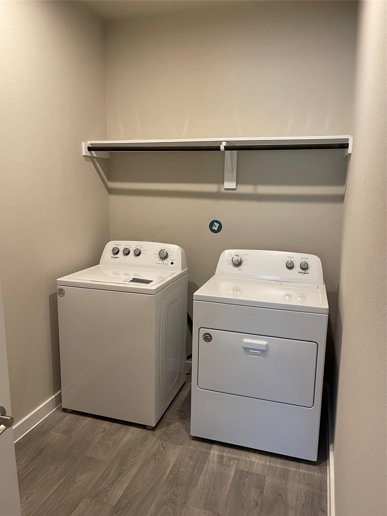 12285 Council Grove Drive, Conroe, TX 77384 Convenient laundry room featuring a washer and dryer with overhead shelving for extra storage.
