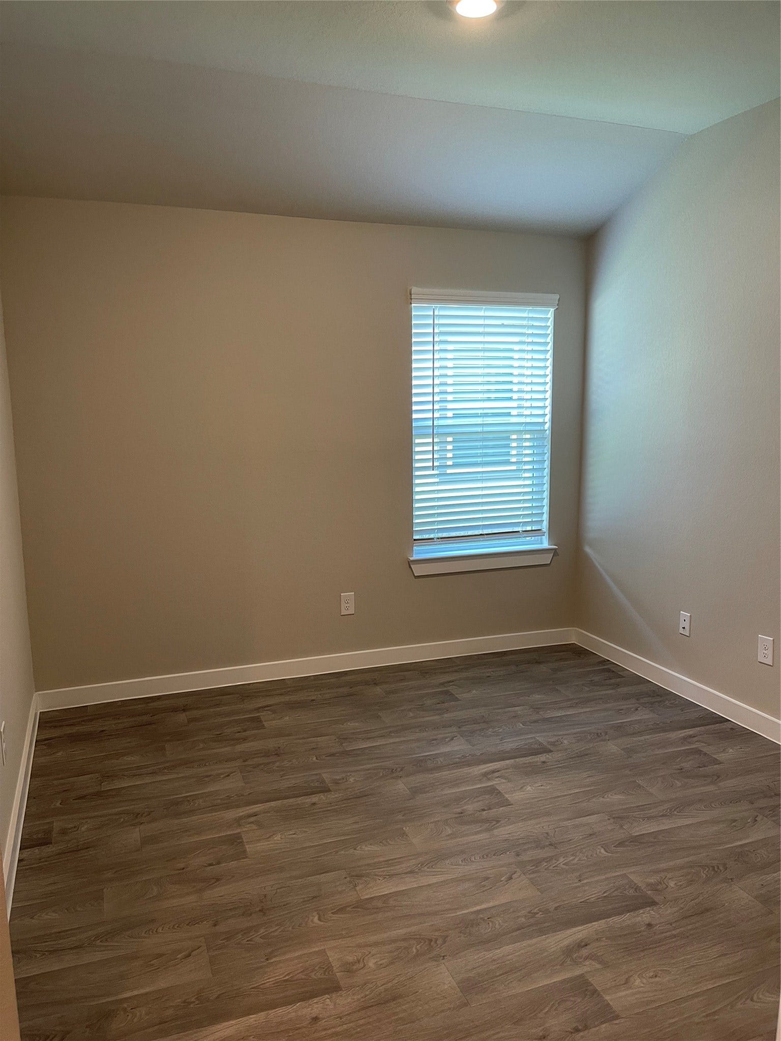 12285 Council Grove Drive, Conroe, TX 77384 Cozy room with neutral walls, and a window allowing natural light to brighten the space.