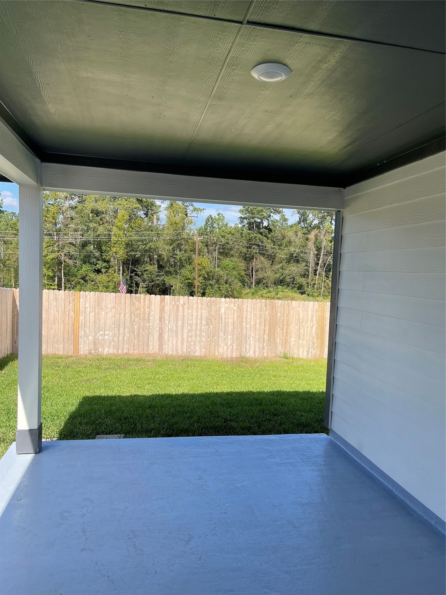 12285 Council Grove Drive, Conroe, TX 77384 Enjoy a covered patio with views of a spacious, fenced backyard, providing a serene outdoor retreat.