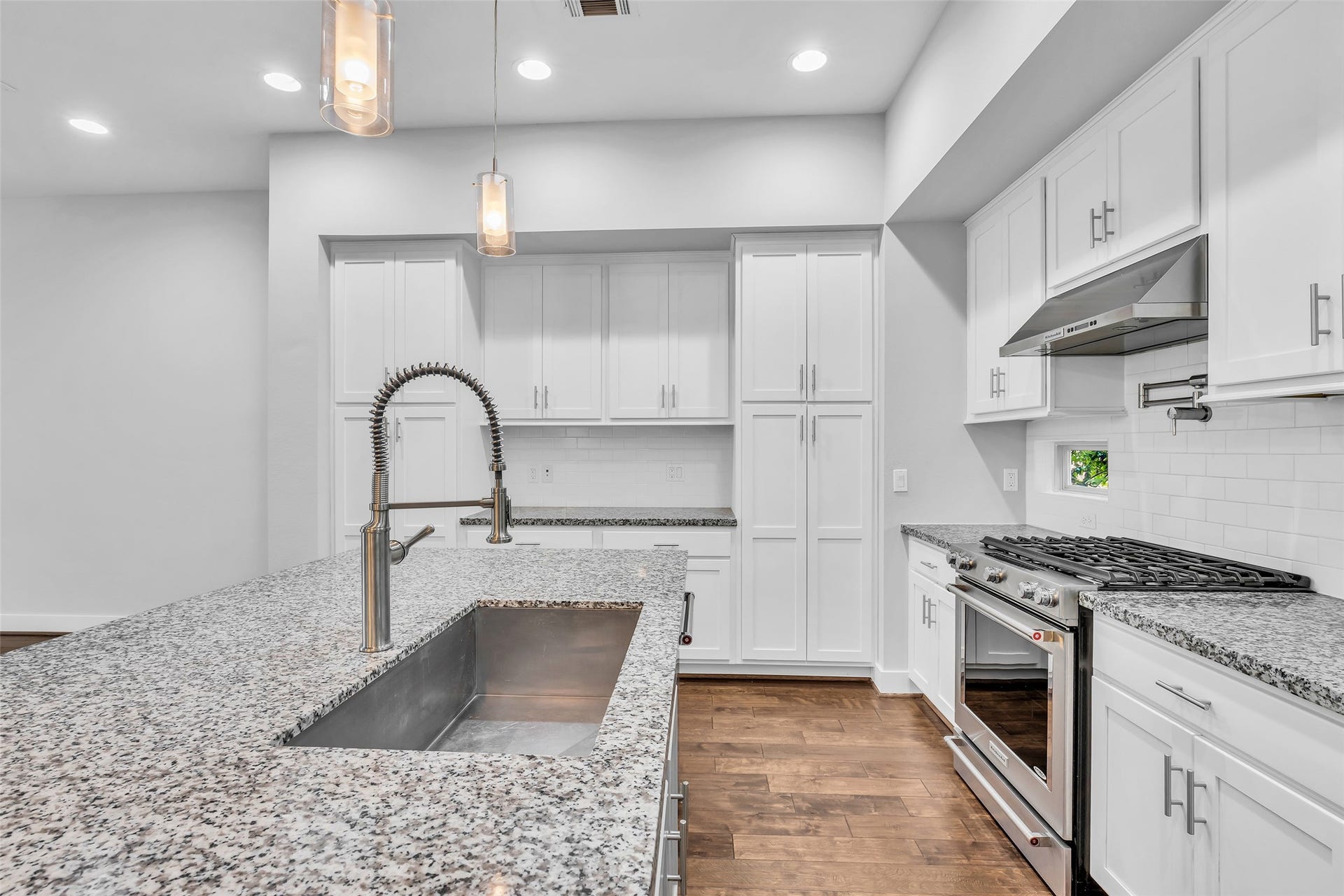 3309 Jefferson Street, #C, Houston, TX 77003 Closer view of the kitchen highlighting granite countertops and ample cabinet storage, providing durable work surfaces and practical space for organization and everyday use.