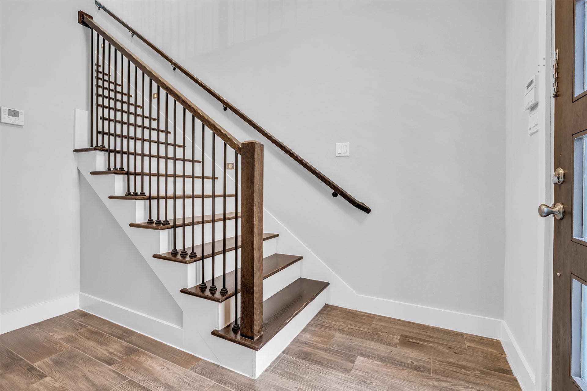 3309 Jefferson Street, #C, Houston, TX 77003 The foyer includes a staircase leading to the second floor, serving as a central transition point between the homes main living areas and the upper level.