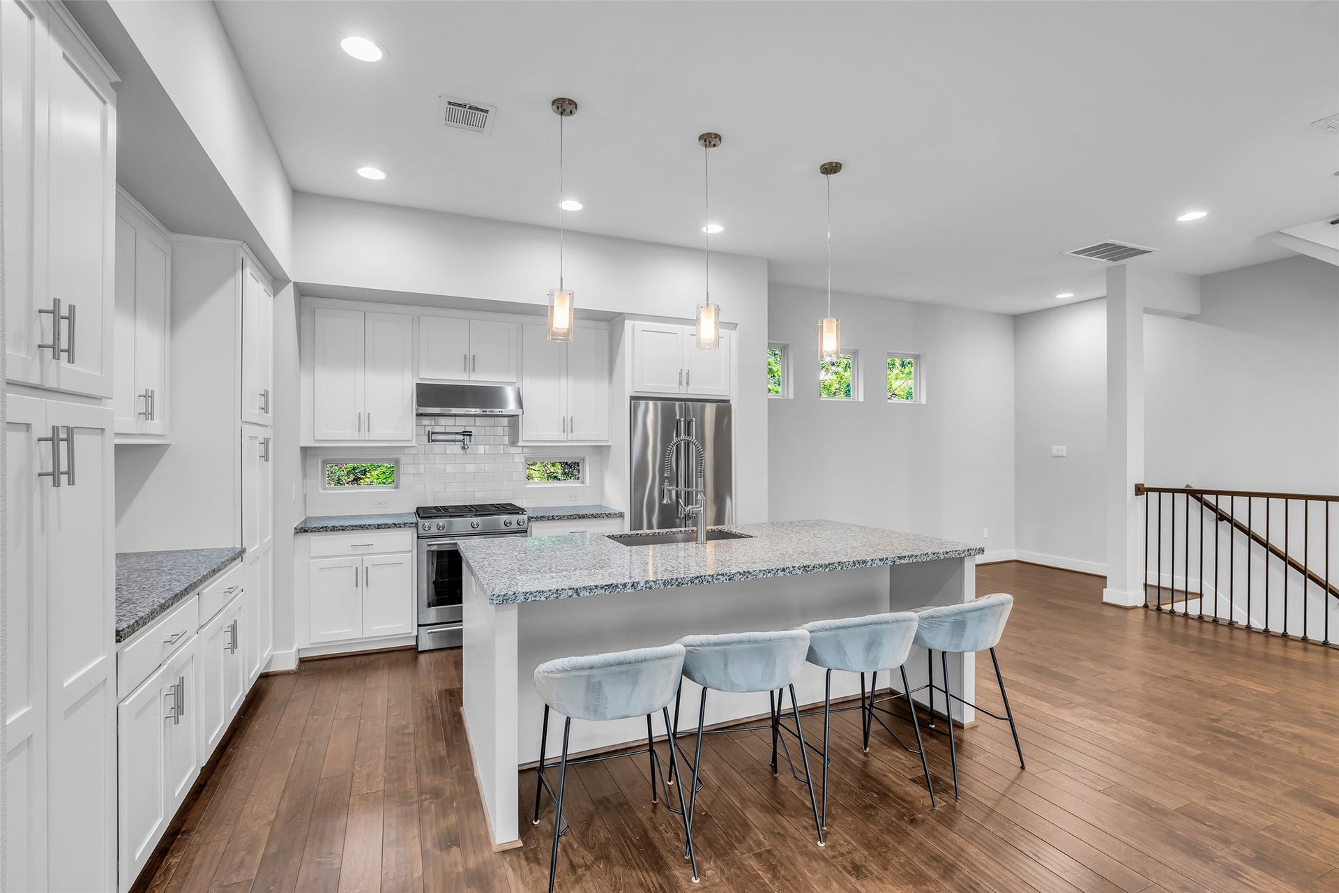 3309 Jefferson Street, #C, Houston, TX 77003 Wide view of the kitchen showing the dining area in the background and the staircase leading down.