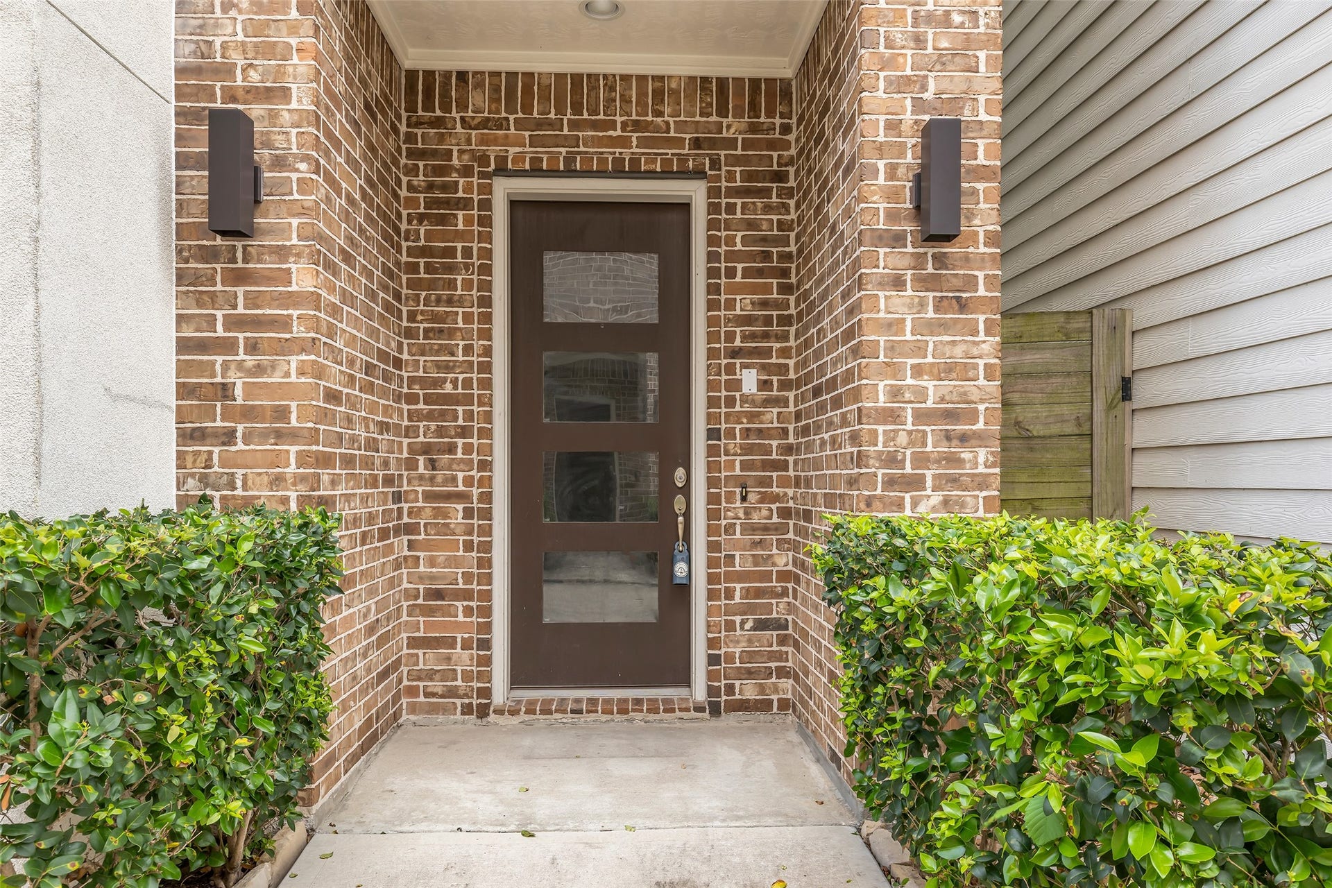 3309 Jefferson Street, #C, Houston, TX 77003 Front entrance area of the home featuring a visible brick accent wall, adding texture and character to the entryway.