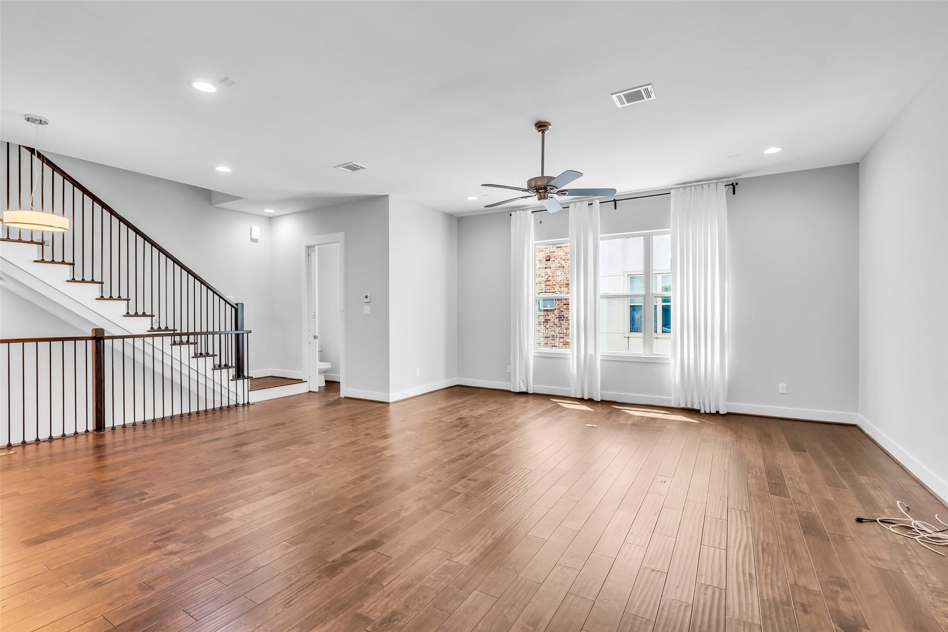 3309 Jefferson Street, #C, Houston, TX 77003 The living room features a large window that fills the space with natural light, creating a bright and airy atmosphere throughout the main living area.