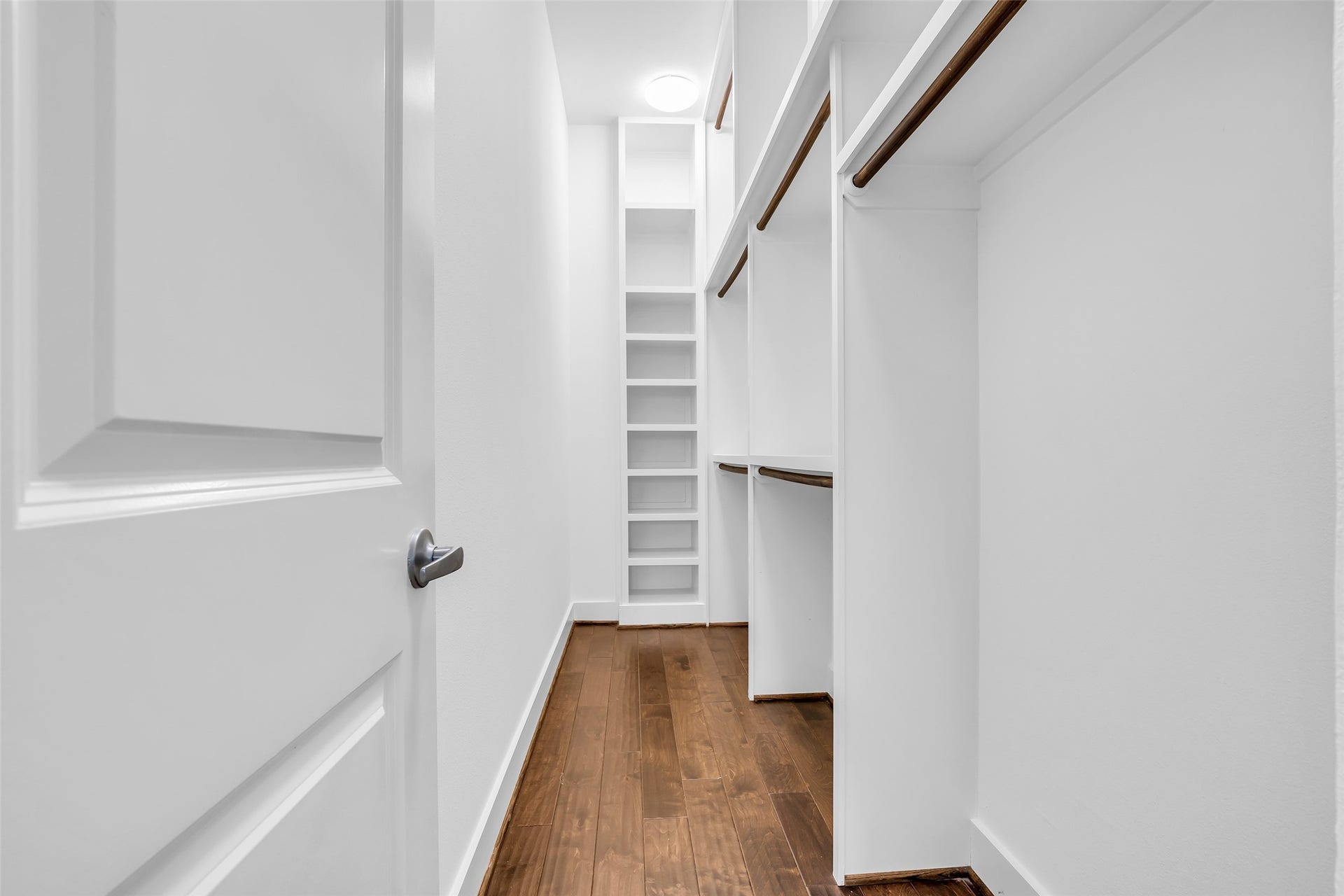 3309 Jefferson Street, #C, Houston, TX 77003 Main bedroom walk-in closet featuring hanging rods and built-in shelves, providing organized storage for clothing and accessories in a practical, well-structured layout.