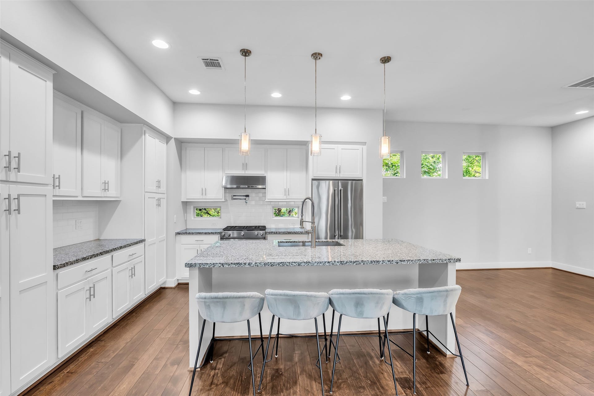 3309 Jefferson Street, #C, Houston, TX 77003 Elegant drop lights hang above the kitchen island, adding focused illumination and a refined touch to the space.