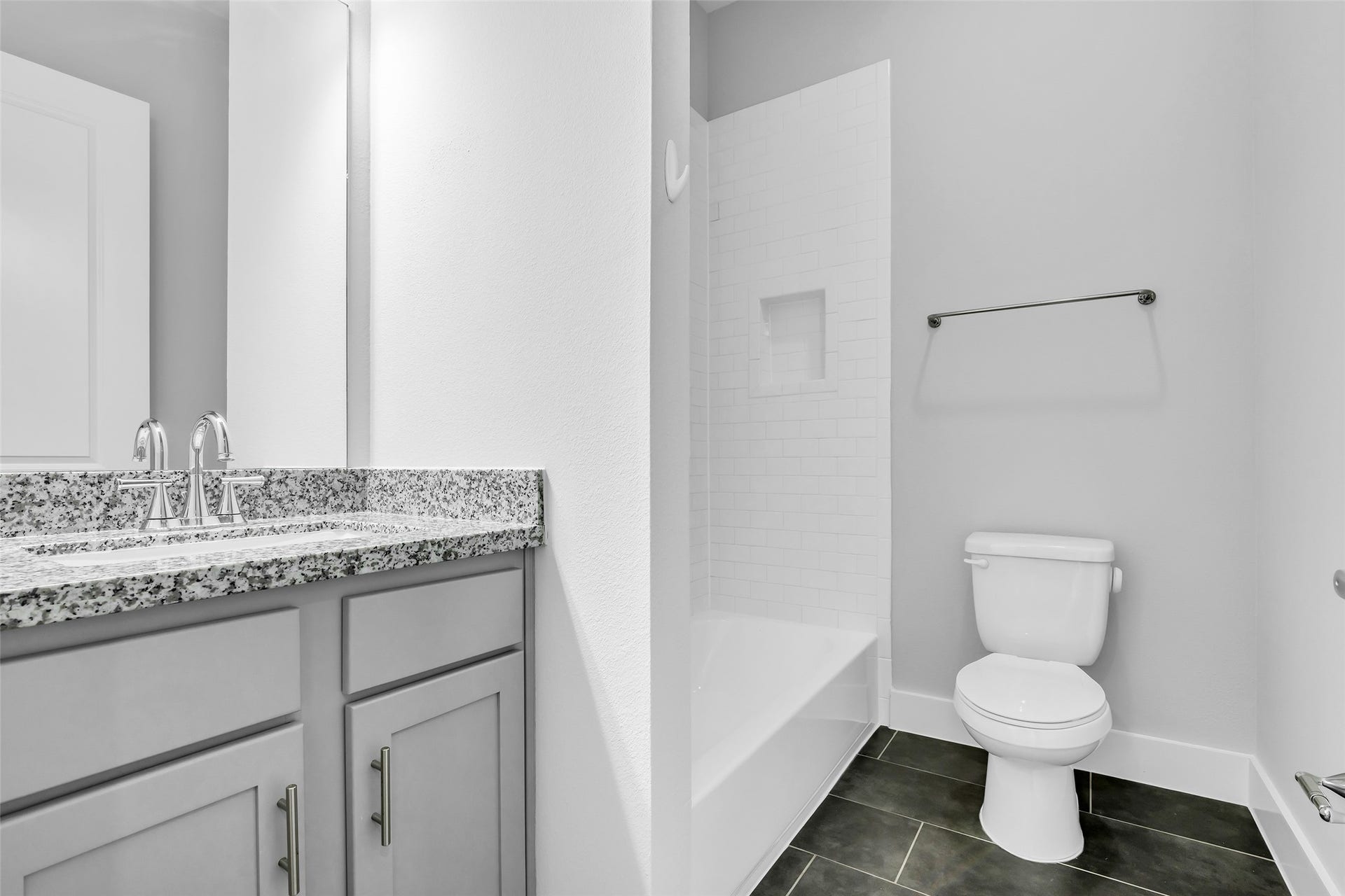 3309 Jefferson Street, #C, Houston, TX 77003 En-suite bathroom of the secondary bedroom featuring a tub and shower combination, finished with the same modern design elements seen throughout the home, providing a clean and cohesive look.