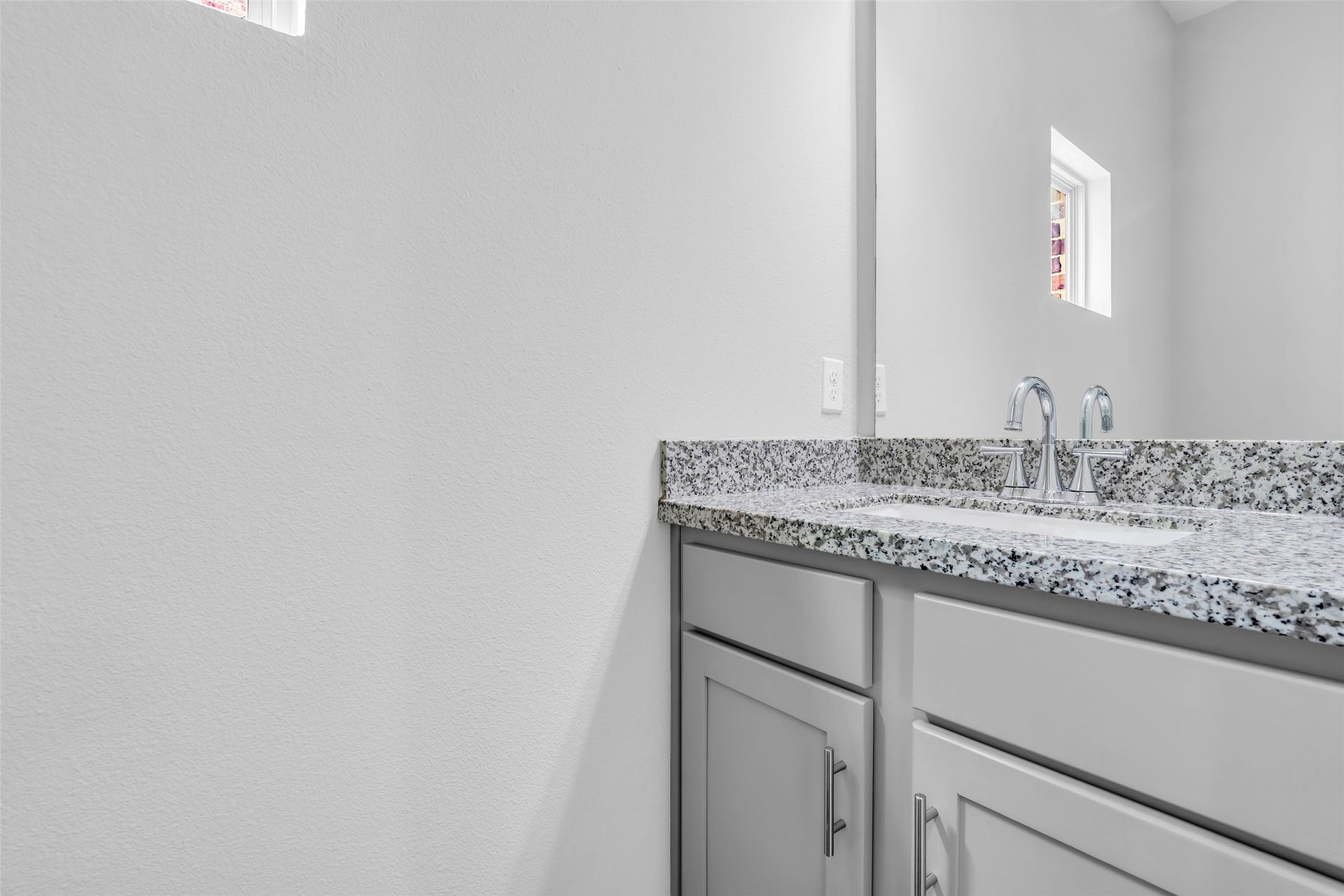3309 Jefferson Street, #C, Houston, TX 77003 Inside the half bathroom featuring a granite countertop, providing a durable and polished surface that complements the clean, functional design of the space.