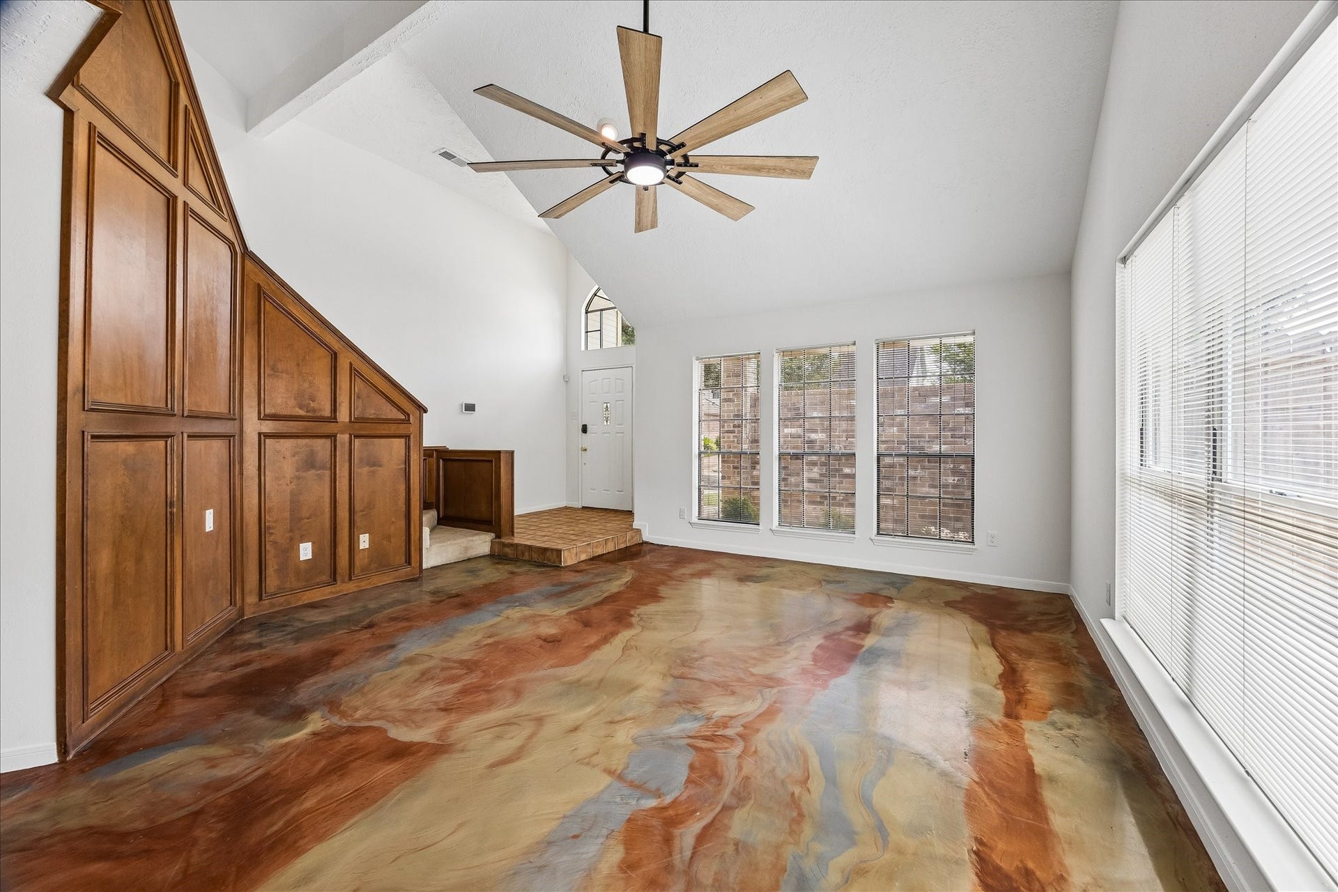 3806 Crystal Falls Drive, Missouri City, TX 77459 Vaulted ceilings, abundant natural light, and custom epoxy flooring create a striking living space.
