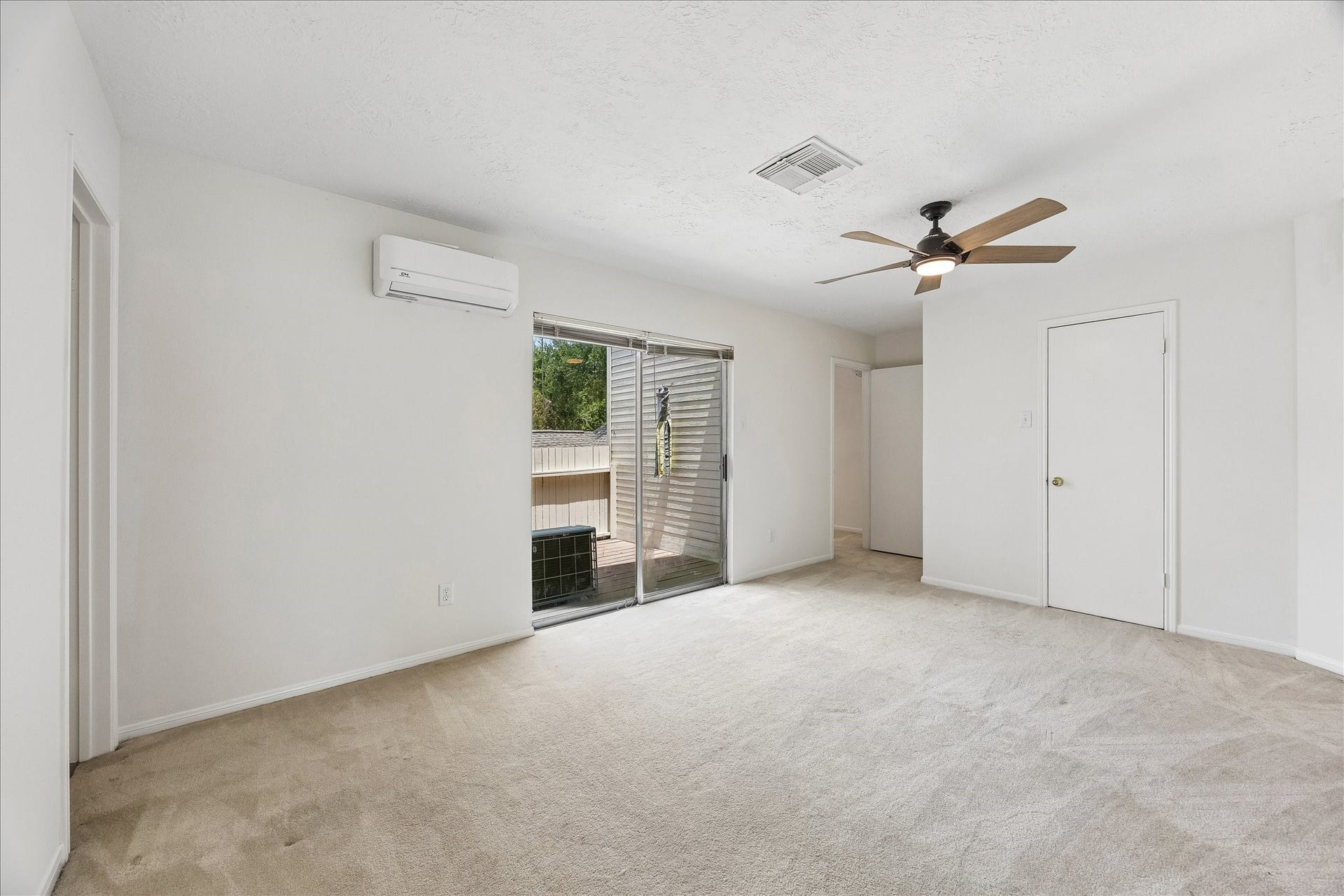 3806 Crystal Falls Drive, Missouri City, TX 77459 Alternate view of the upstairs primary highlights the spacious layout, private balcony access, and abundant natural light.