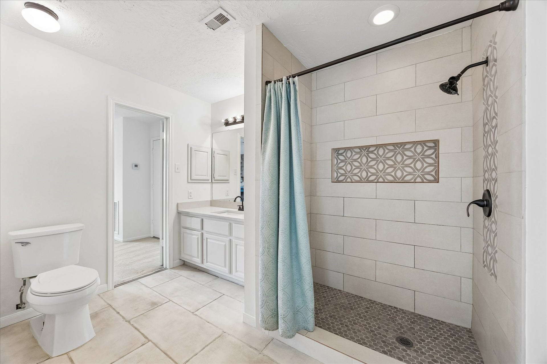 3806 Crystal Falls Drive, Missouri City, TX 77459 Upstairs second primary bath features a spacious walk-in shower with decorative tile accents.