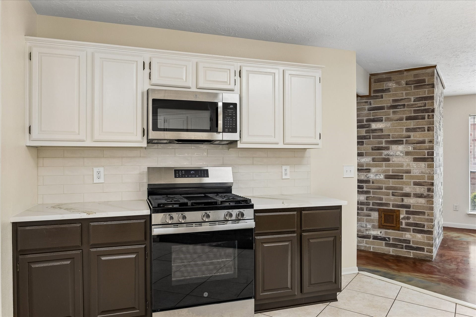 3806 Crystal Falls Drive, Missouri City, TX 77459 Updated countertops and subway tile backsplash complement stainless steel appliances and two-tone cabinetry.
