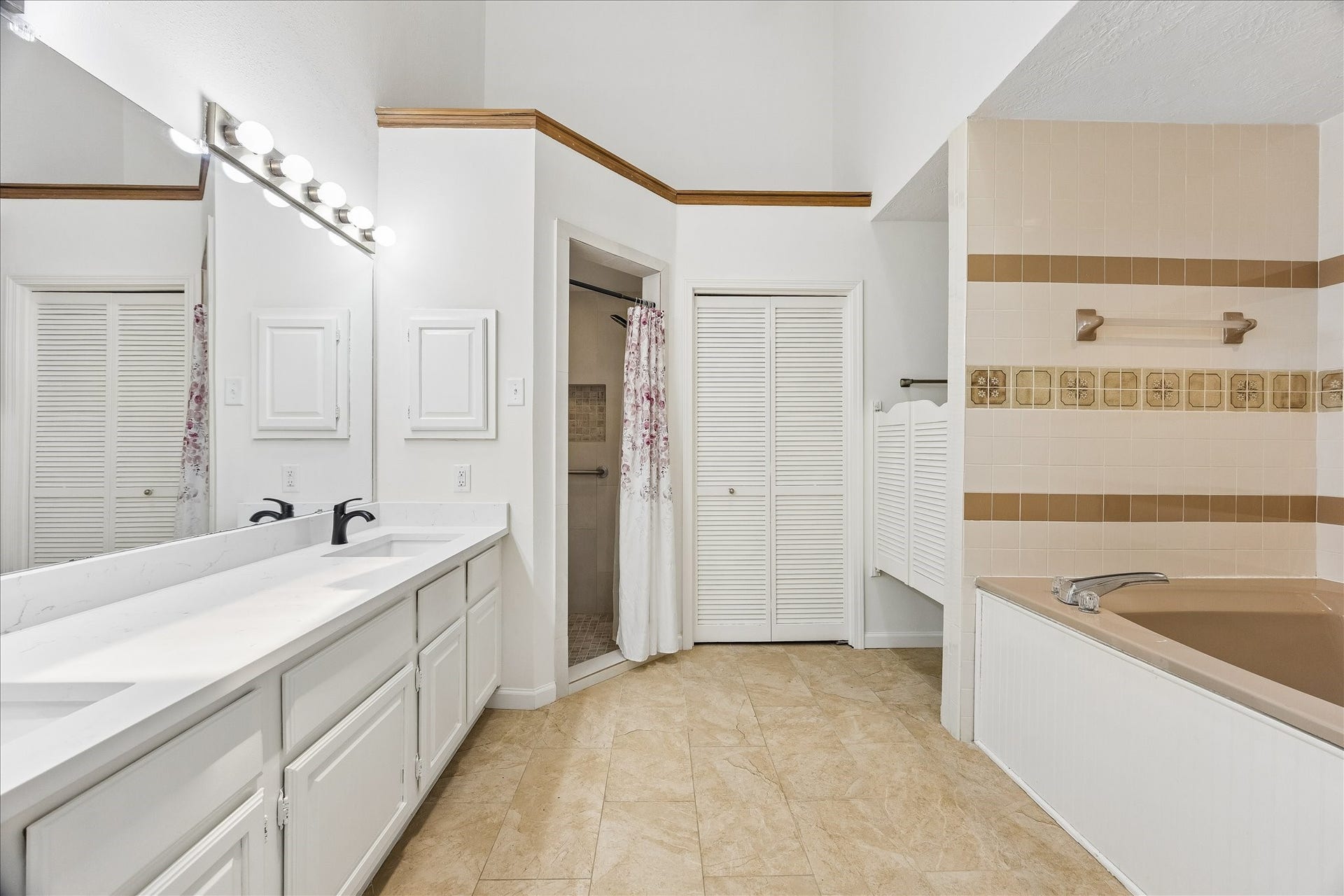 3806 Crystal Falls Drive, Missouri City, TX 77459 Spacious primary bath features dual sinks, generous storage, a soaking tub, and separate shower.
