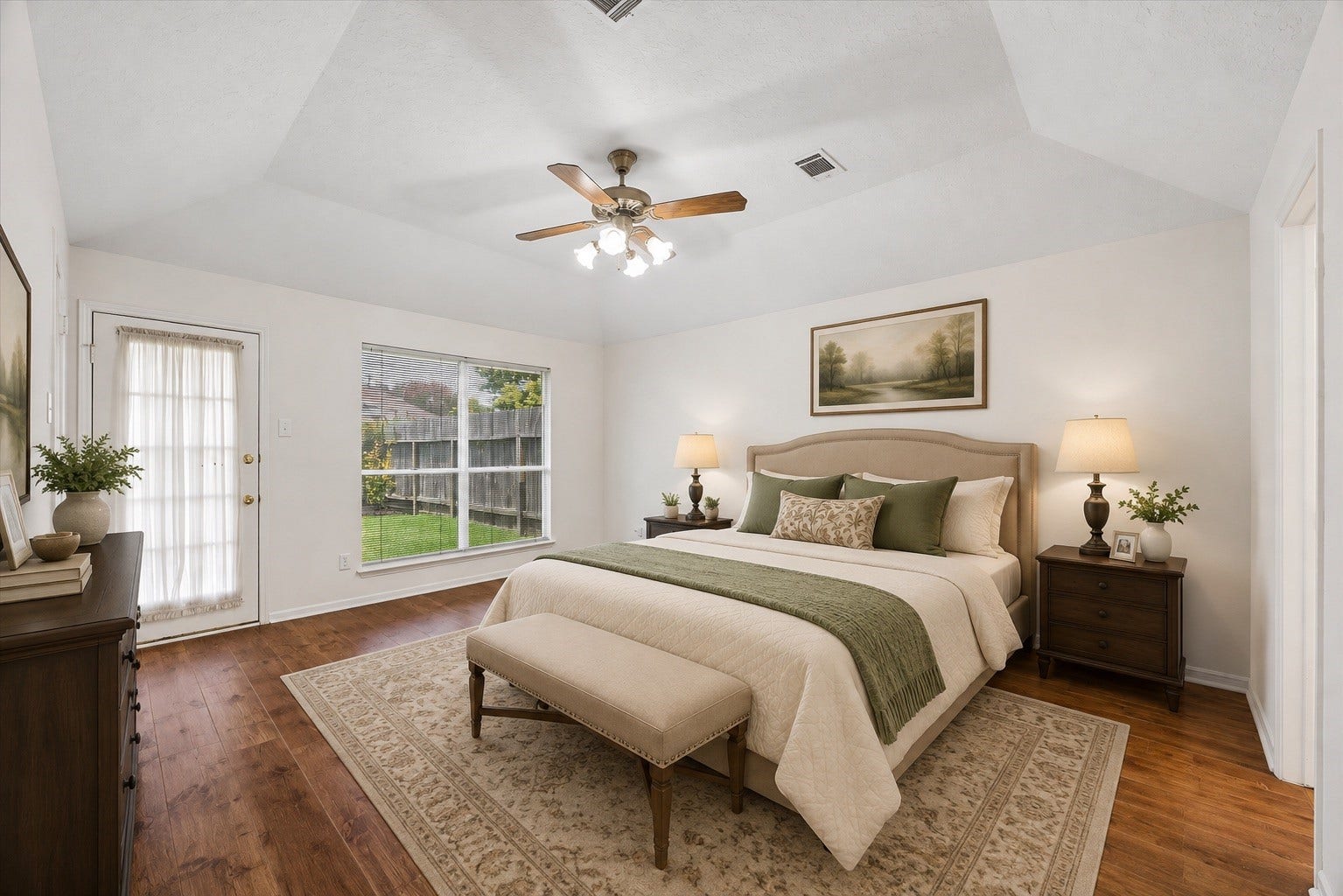 3806 Crystal Falls Drive, Missouri City, TX 77459 Virtually Staged - Spacious downstairs primary retreat with warm wood flooring, tray ceiling, abundant natural light, and backyard access.