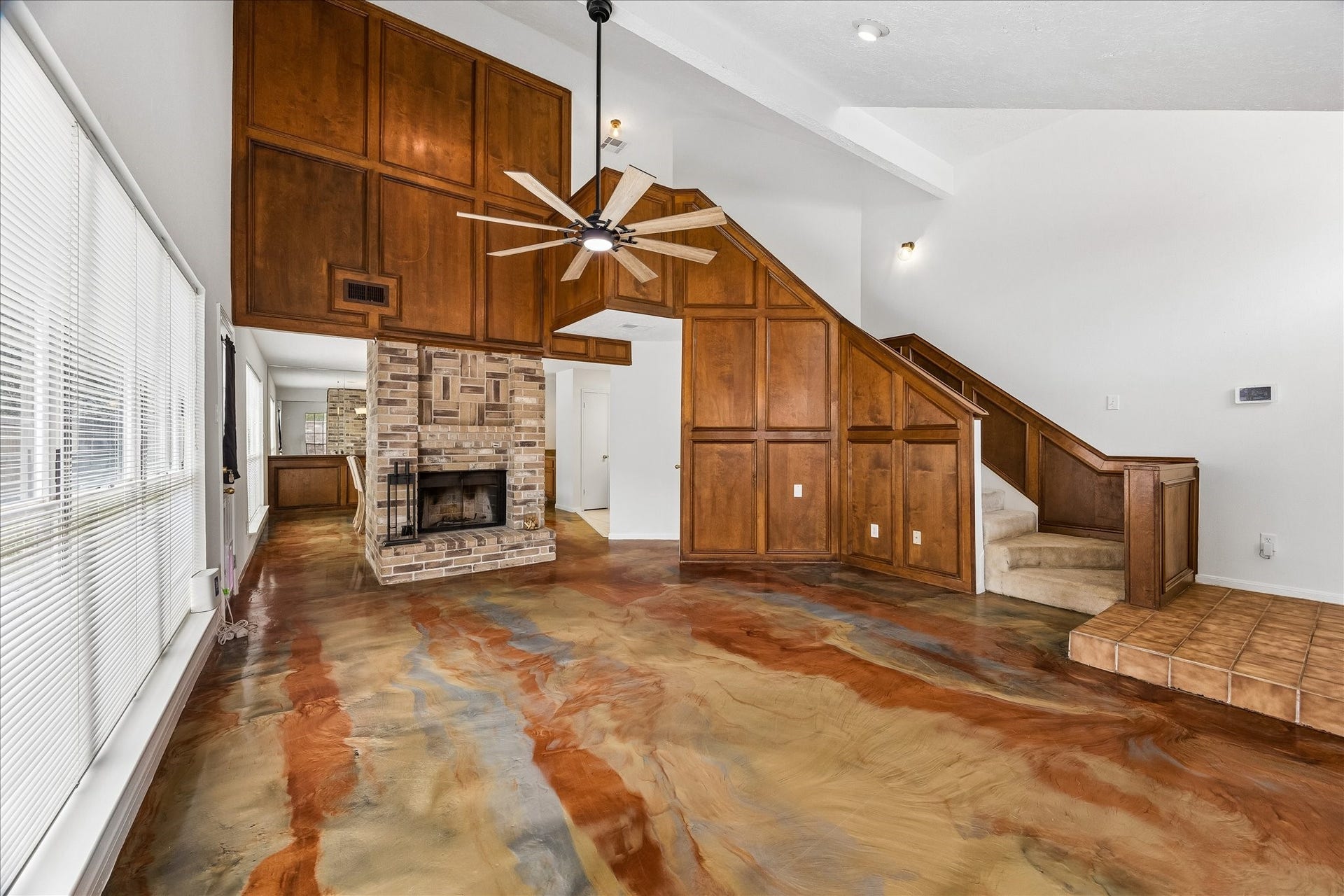 3806 Crystal Falls Drive, Missouri City, TX 77459 Rich woodwork and a brick fireplace add warmth and character to the soaring living space.