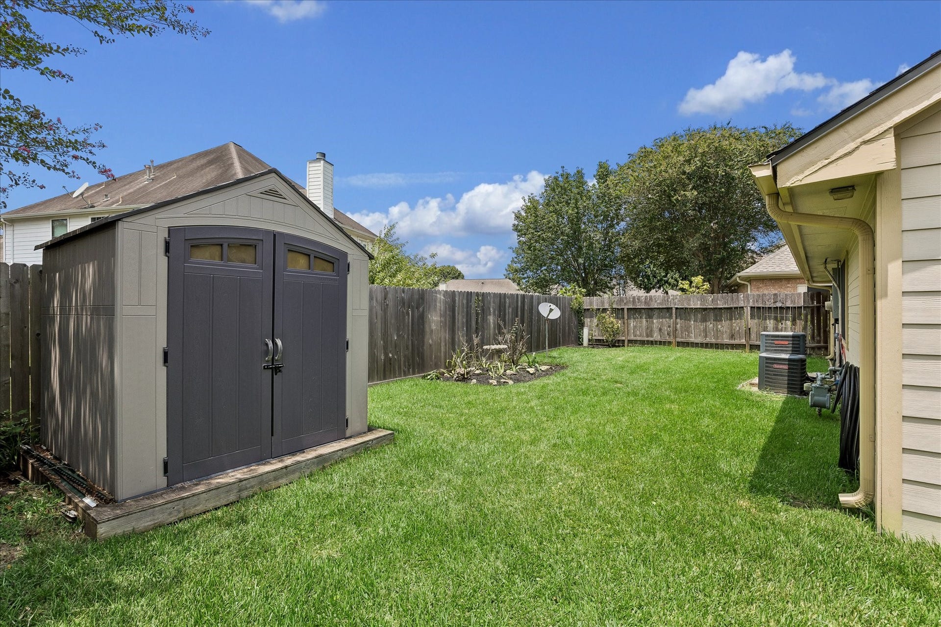3806 Crystal Falls Drive, Missouri City, TX 77459 Fenced backyard includes a convenient storage shed while preserving plenty of usable lawn space.