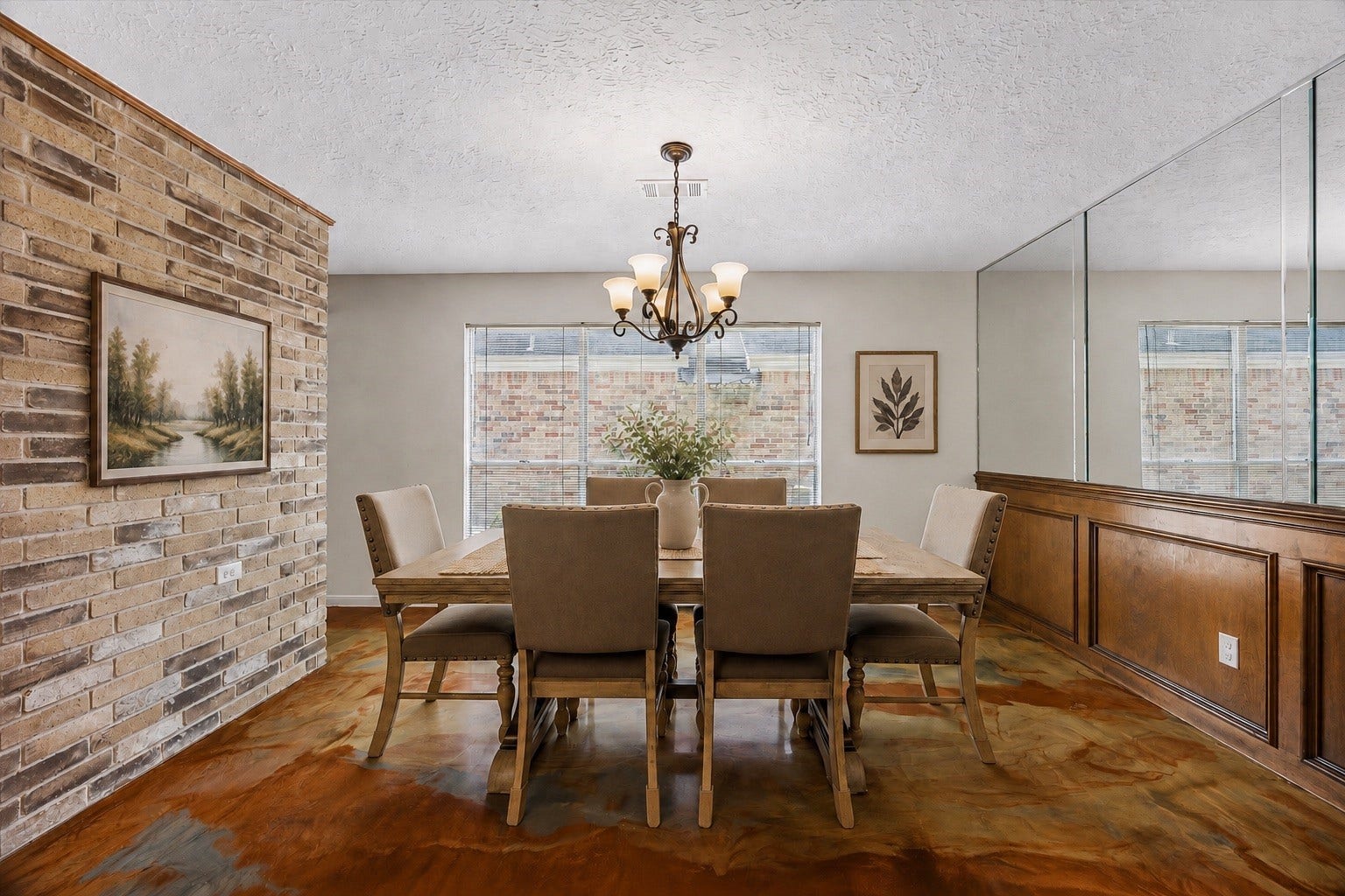 3806 Crystal Falls Drive, Missouri City, TX 77459 Virtually Staged - Formal dining area with a statement chandelier, large window, custom wood wainscoting, and mirrored accent wall.