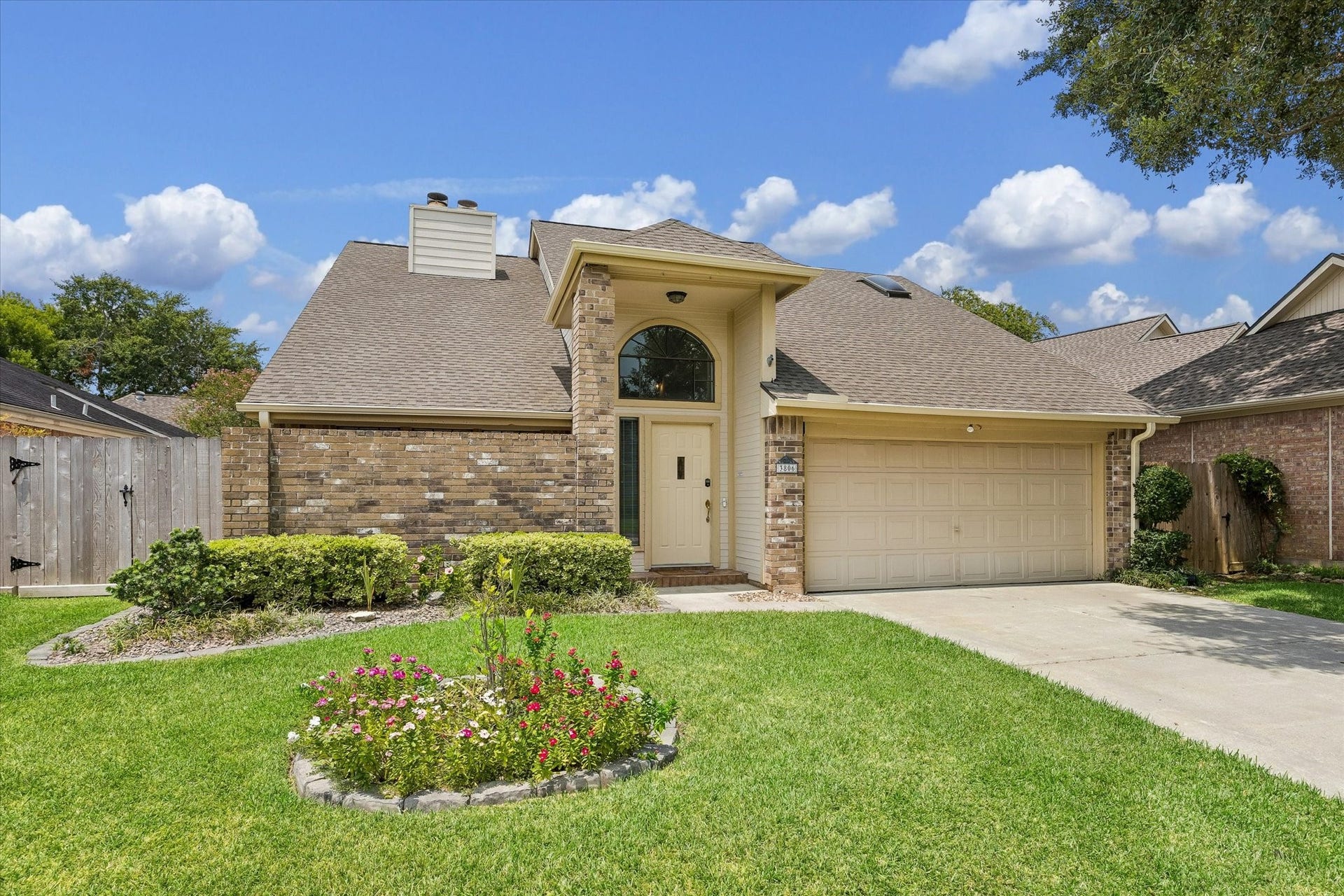 3806 Crystal Falls Drive, Missouri City, TX 77459 Inviting curb appeal with lush landscaping, a manicured lawn, and welcoming covered entry.