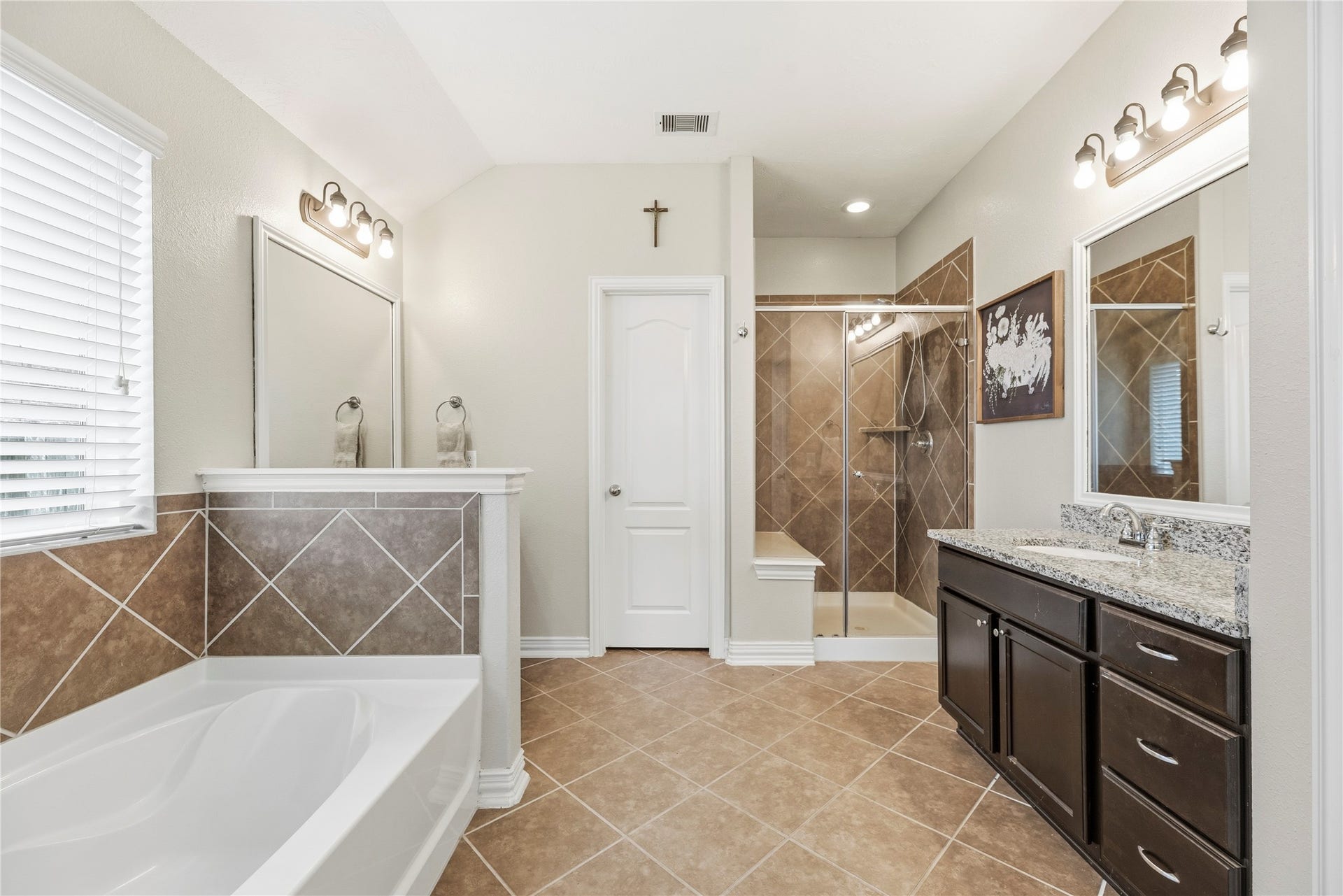 16014 Mark Crest Drive, Hockley, TX 77447 The primary bathroom is complete with dual granite vanities, soaking tub, separate shower and walk-in closet.