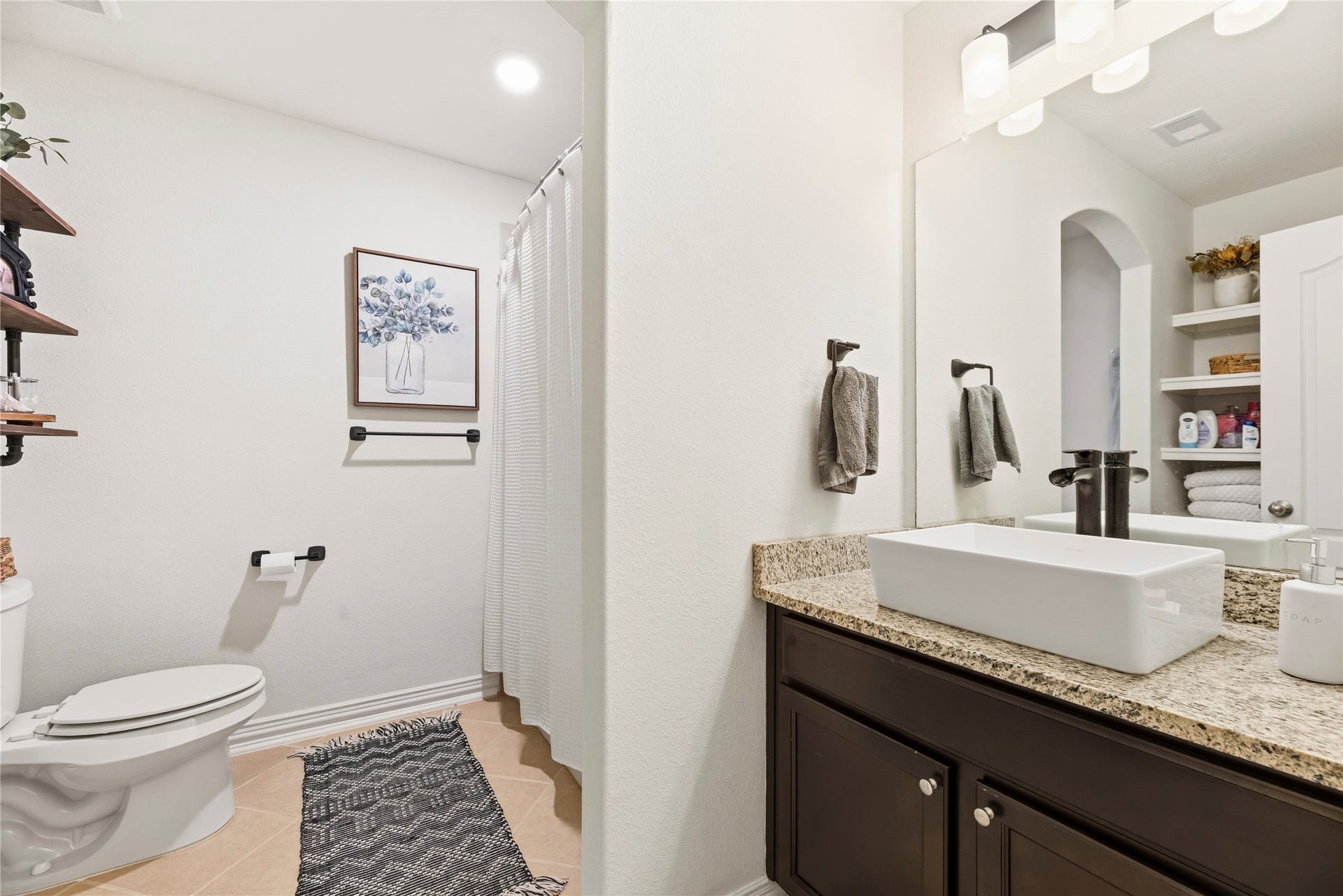 16014 Mark Crest Drive, Hockley, TX 77447 Full guest bathroom with built-in shelving and a tub/shower combination.