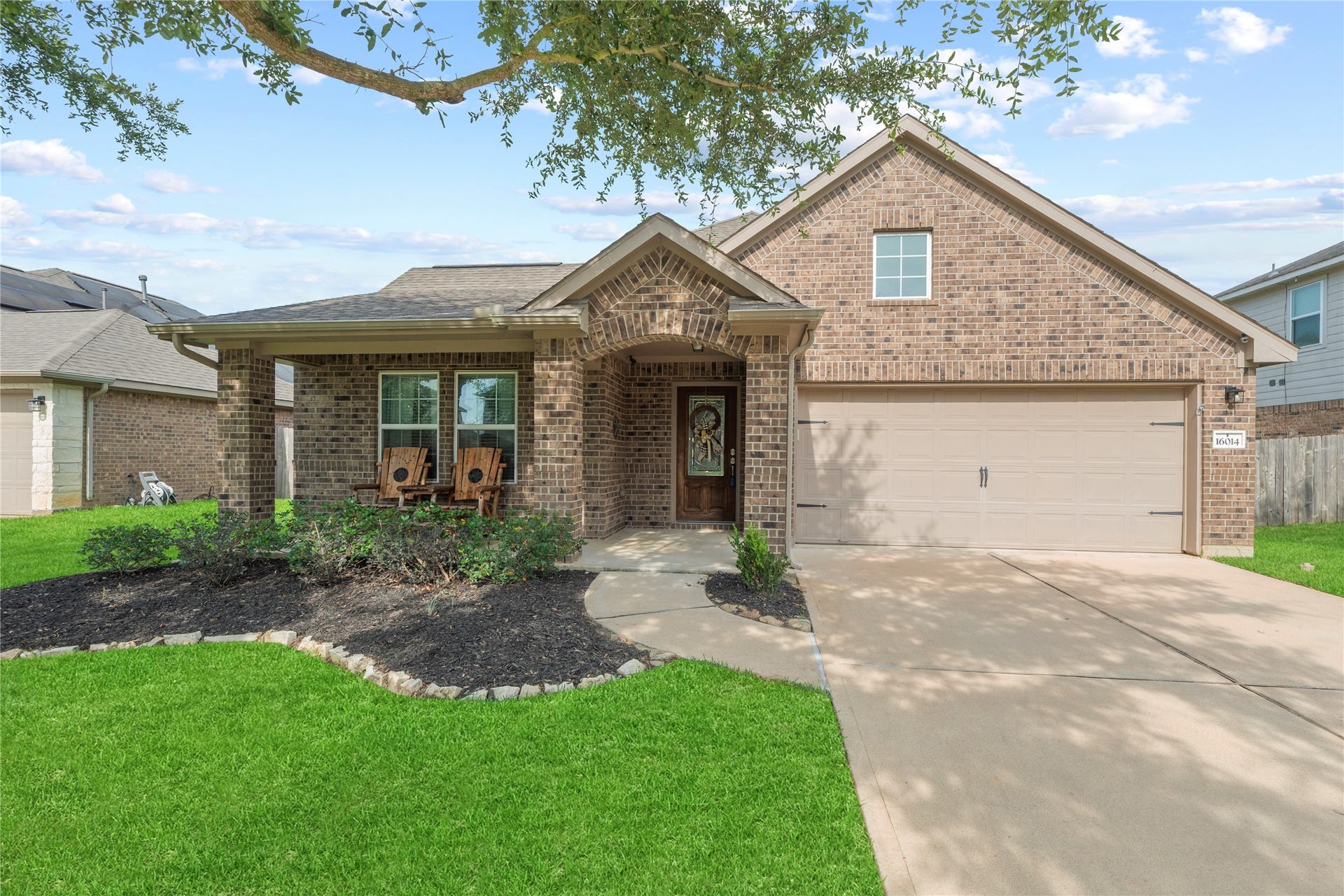 16014 Mark Crest Drive, Hockley, TX 77447 One-story home with a 2-car attached garage, double-wide driveway and charming front porch.