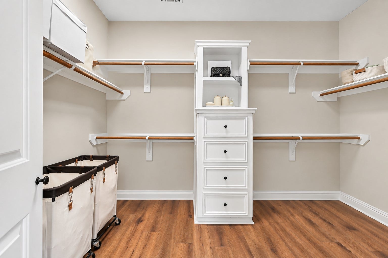 2505 Sarasota Drive, Friendswood, TX 77546 An oversized primary walk-in closet provides extensive hanging and storage space with built-in shelving, double hanging rods and a center drawer tower. Its generous dimensions offer plenty of room to keep clothing, shoes and accessories organized.