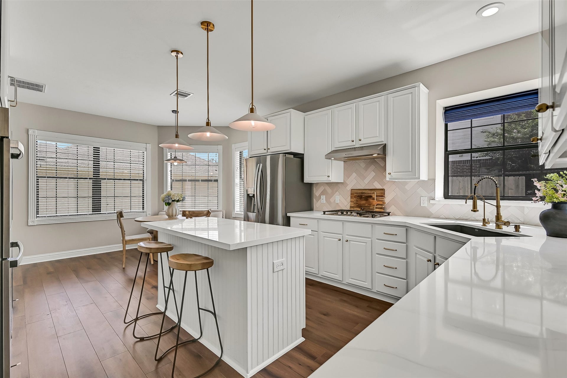 2505 Sarasota Drive, Friendswood, TX 77546 The island kitchen opens directly to a sunny breakfast area surrounded by windows. With abundant cabinetry, generous counter space, stainless appliances and plenty of room for casual dining, this inviting space serves as a natural hub of the home.