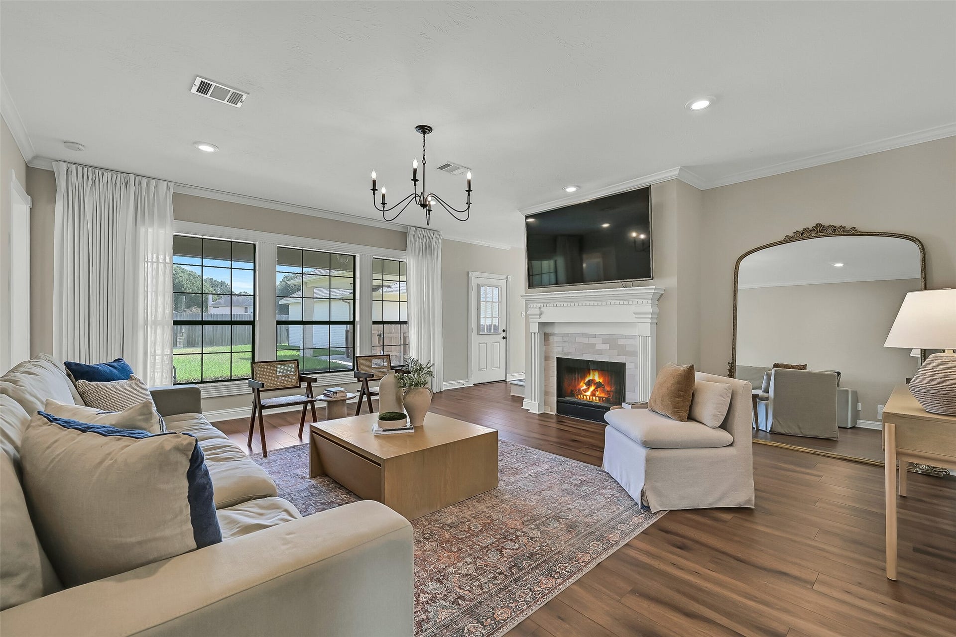 2505 Sarasota Drive, Friendswood, TX 77546 Walls of windows fill the family room with natural light while offering views of the expansive backyard. A gas-log fireplace provides a welcoming focal point, and the open connection to the breakfast area makes the layout ideal for gathering with family and friends.