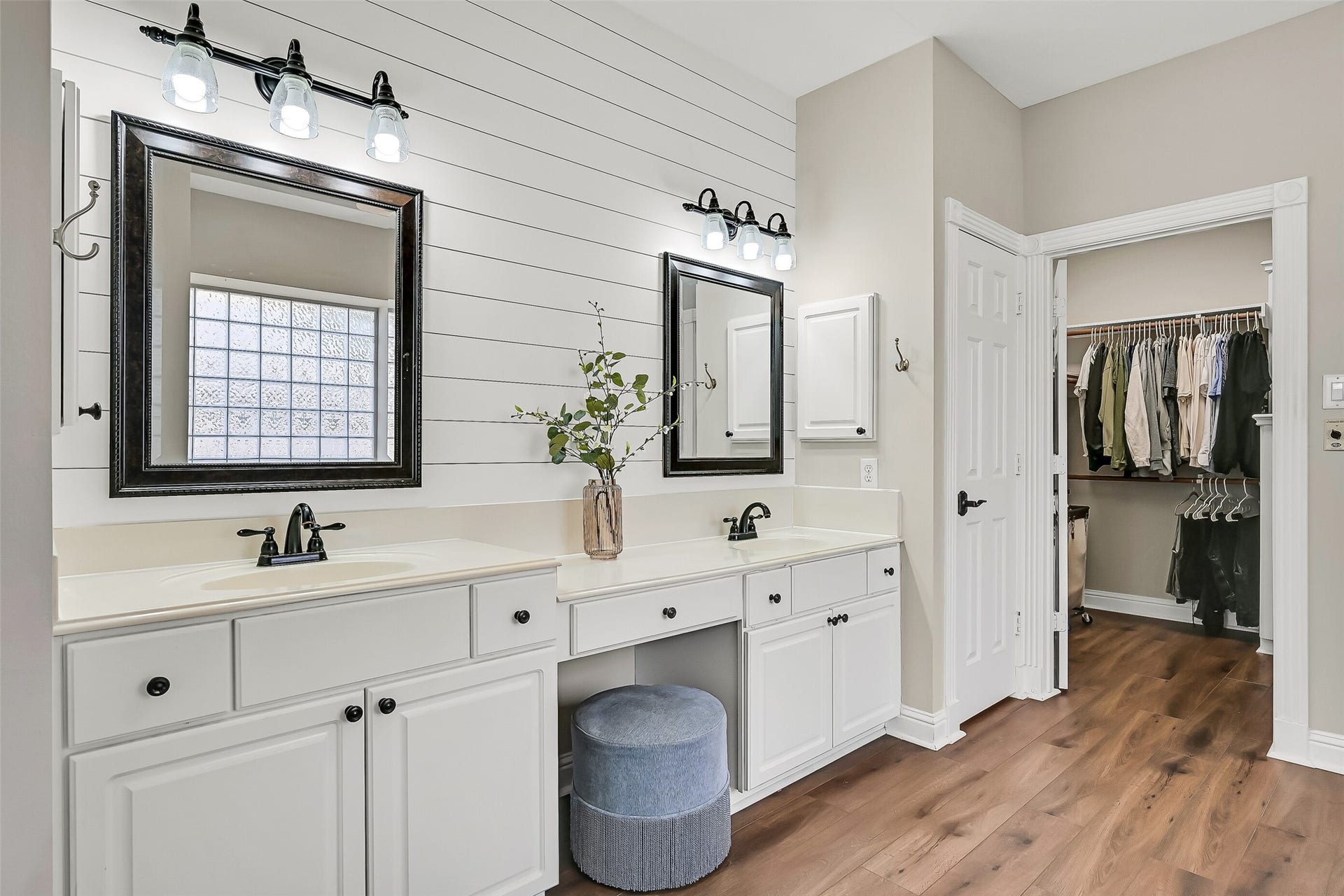 2505 Sarasota Drive, Friendswood, TX 77546 A closer view highlights the dual vanities with separate framed mirrors, generous counter space & dedicated makeup area. The oversized walk-in closet is located directly off the bath, providing extensive built-in storage just steps from the primary suite.