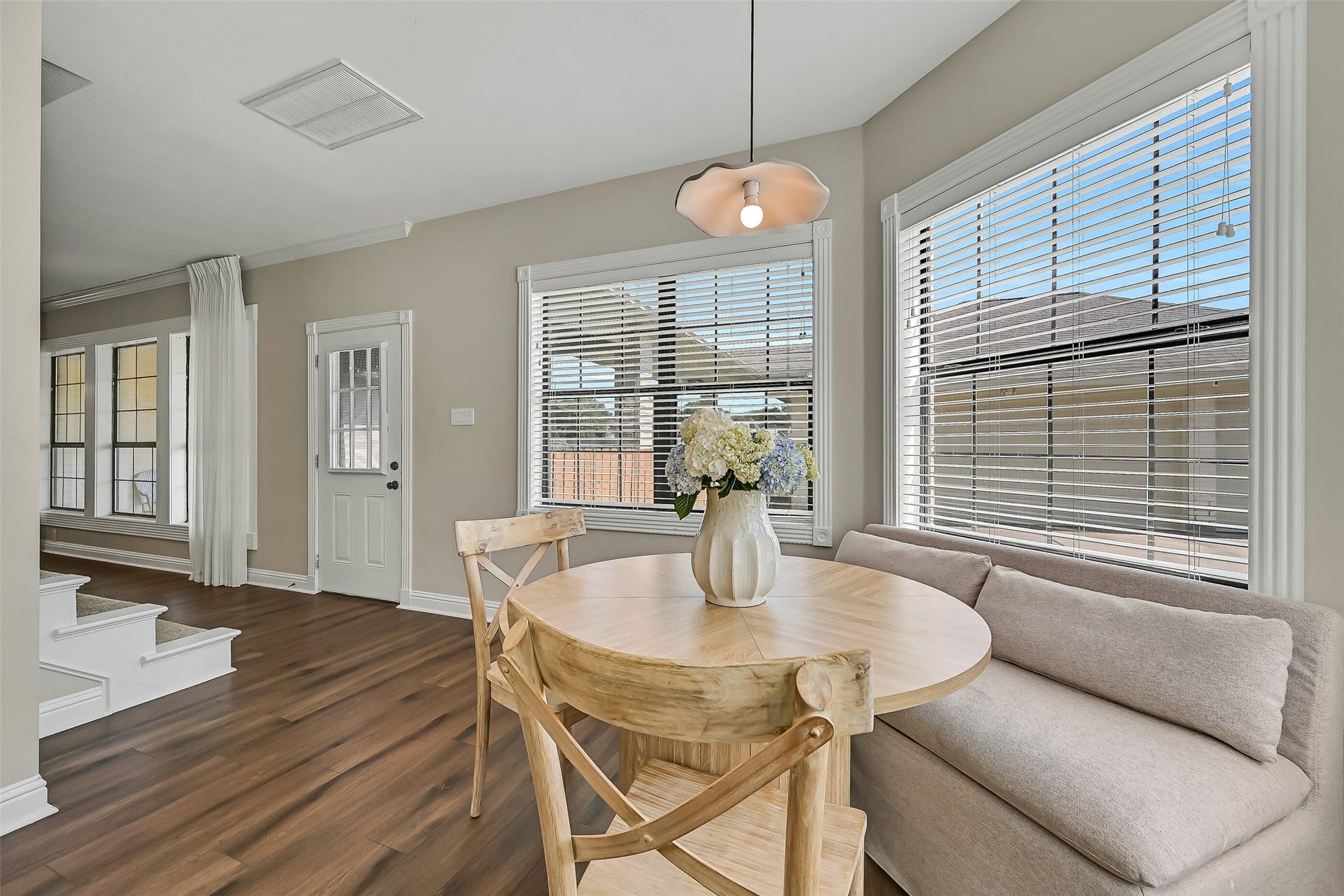 2505 Sarasota Drive, Friendswood, TX 77546 From the family room, the floor plan flows naturally into the sunny breakfast area and kitchen. Luxury vinyl plank flooring unifies the spaces, while numerous windows bring in natural light and provide views across the large fenced backyard.
