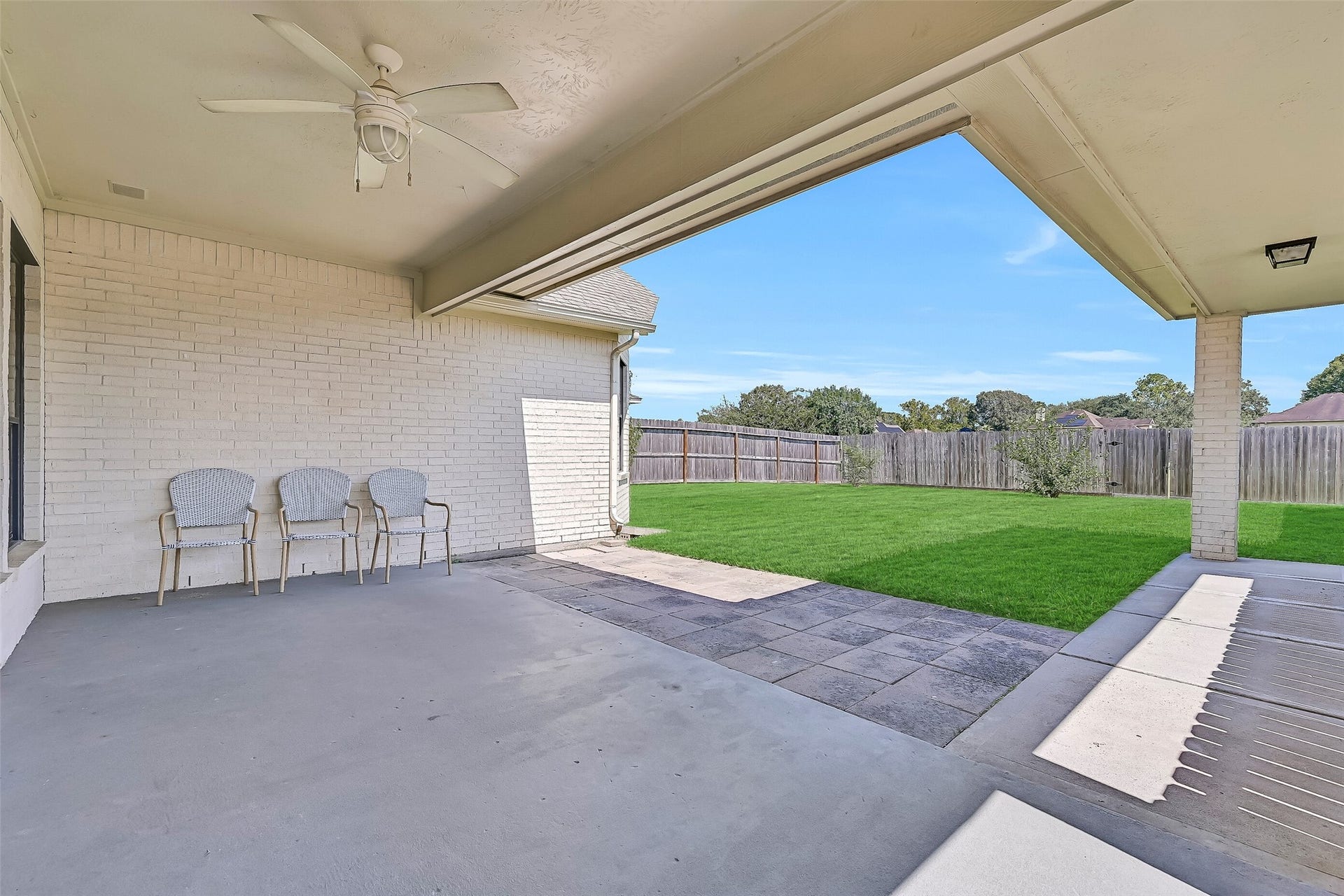 2505 Sarasota Drive, Friendswood, TX 77546 Step outside to a large covered patio extending across the rear of the home and connecting toward the detached garage. A ceiling fan and generous covered area create a shaded spot for outdoor dining, relaxing or entertaining throughout the year.