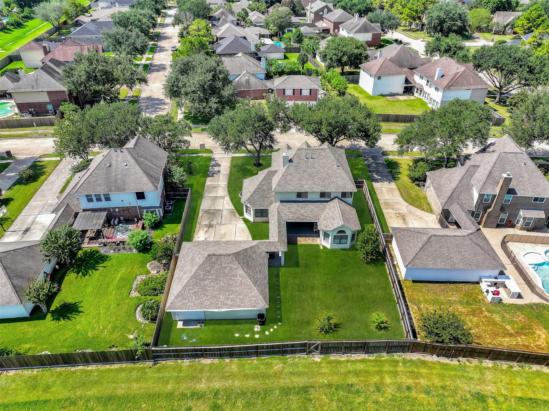 2505 Sarasota Drive, Friendswood, TX 77546 A wide backyard view showcases just how much usable outdoor space this property offers. The large fenced lawn is complemented by a substantial covered patio, detached 3-car garage and the added privacy of having no immediate rear neighbors.