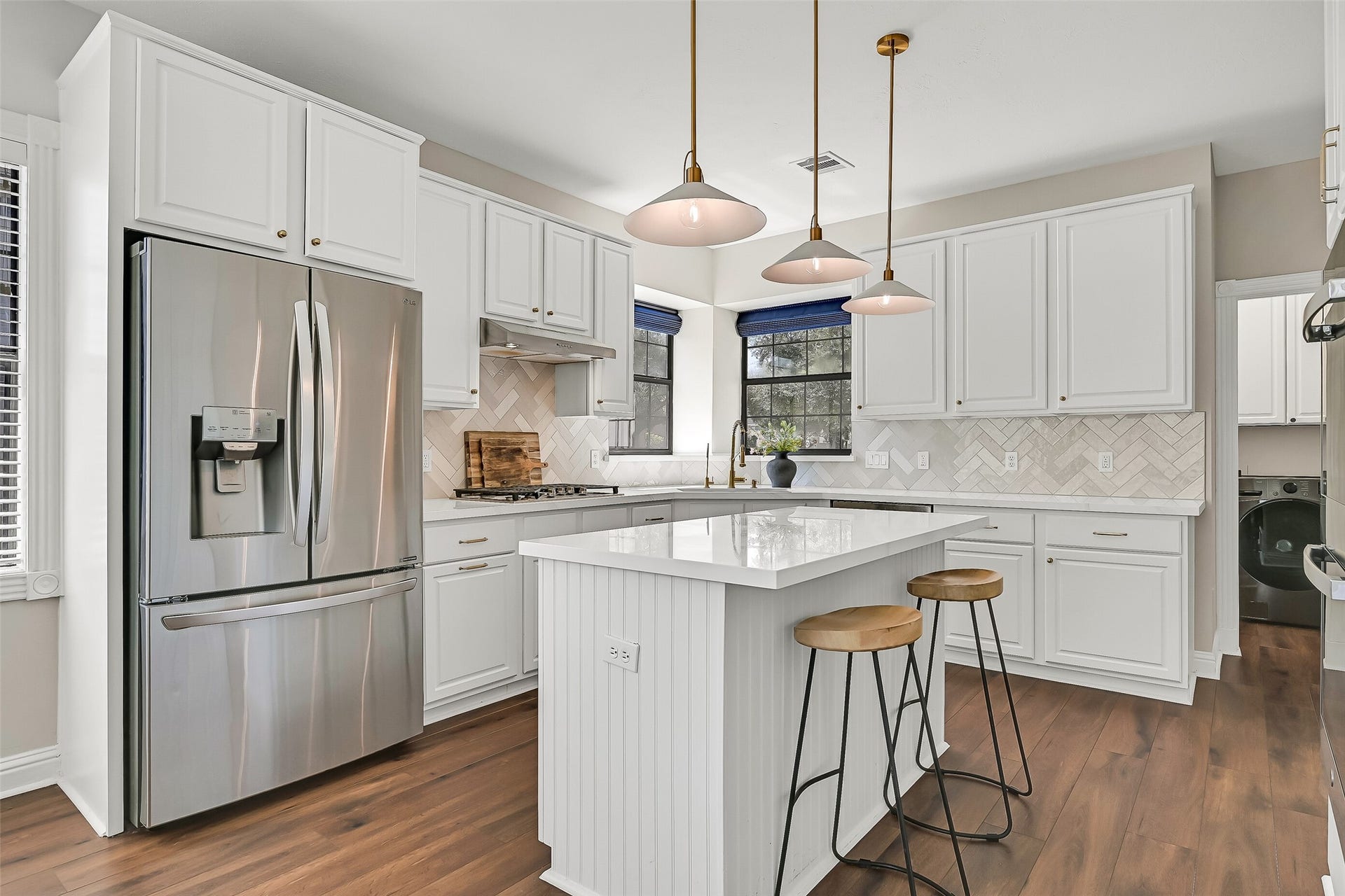 2505 Sarasota Drive, Friendswood, TX 77546 Bright and beautifully updated, the island kitchen features quartzite countertops, white soft-close cabinetry, gold-tone hardware, a herringbone tile backsplash and stainless steel appliances. The oversized island provides additional prep space, storage & casual seating.