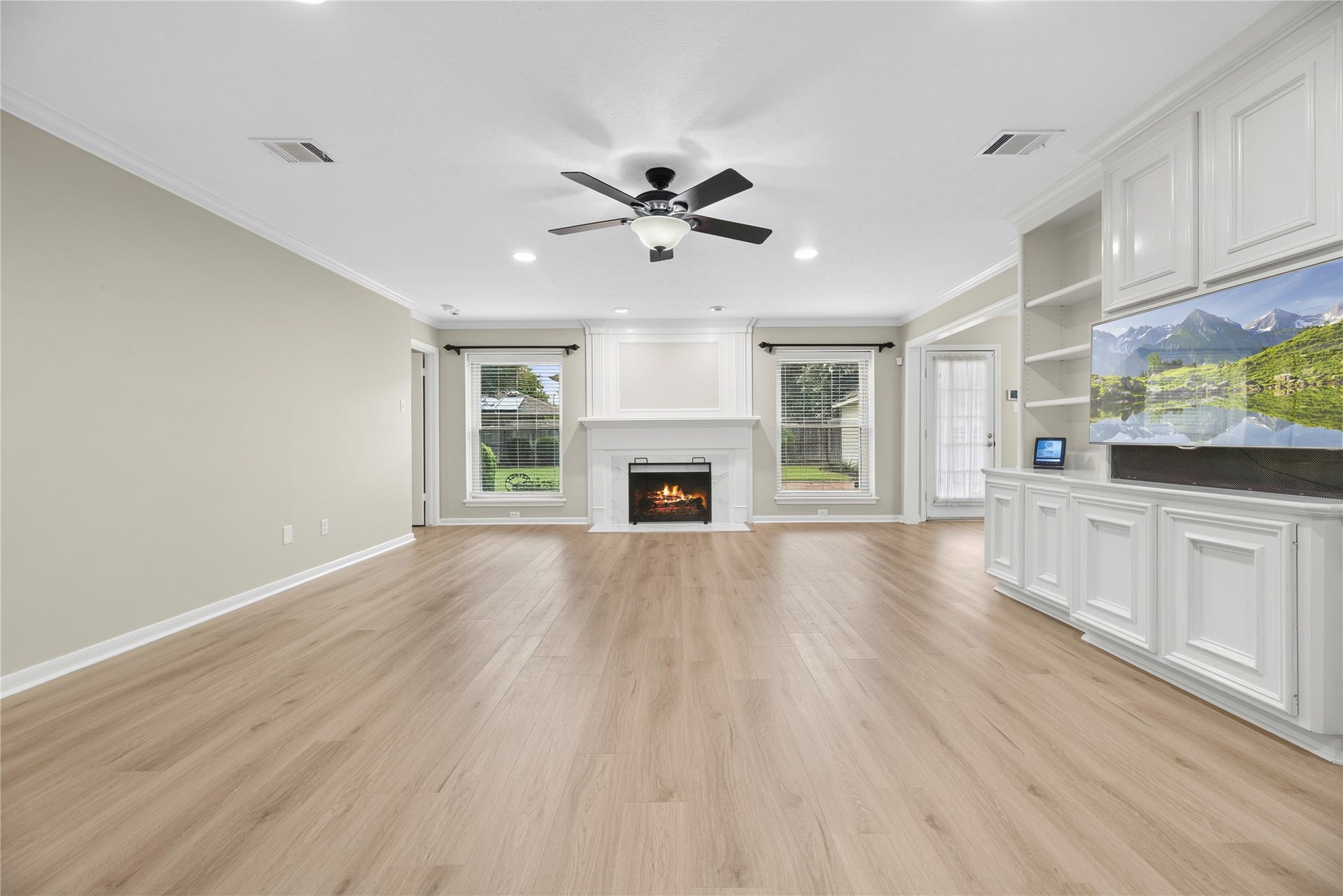 7426 Foxton Place Court, Houston, TX 77095 Competing for equal attention, the gas-log fireplace with its elegant porcelain surround offers the perfect spot for a favorite portrait, while the wall of custom built-ins is ready to showcase treasured collectibles and special keepsakes.