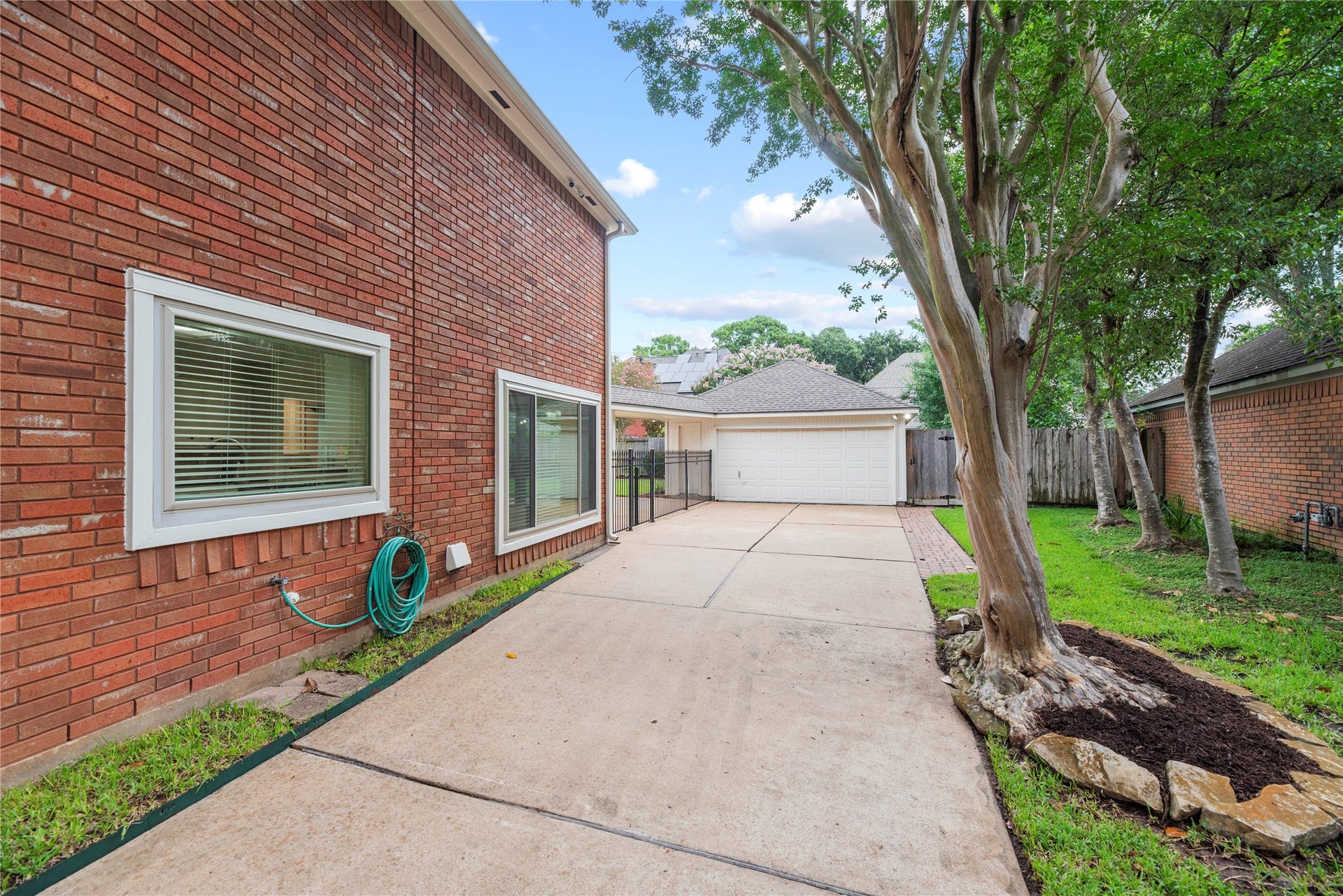 7426 Foxton Place Court, Houston, TX 77095 A long driveway leads to the detached 2-car garage with 3 remote openers, while a 2021 roof, vinyl double-pane windows including select sliders installed in Oct 2020, condenser units & evaporator coils replaced in June 2019, a full-yard sprinkler system & 4 wired outdoor cameras with app capability for remote monitoring add everyday convenience & peace of mind.