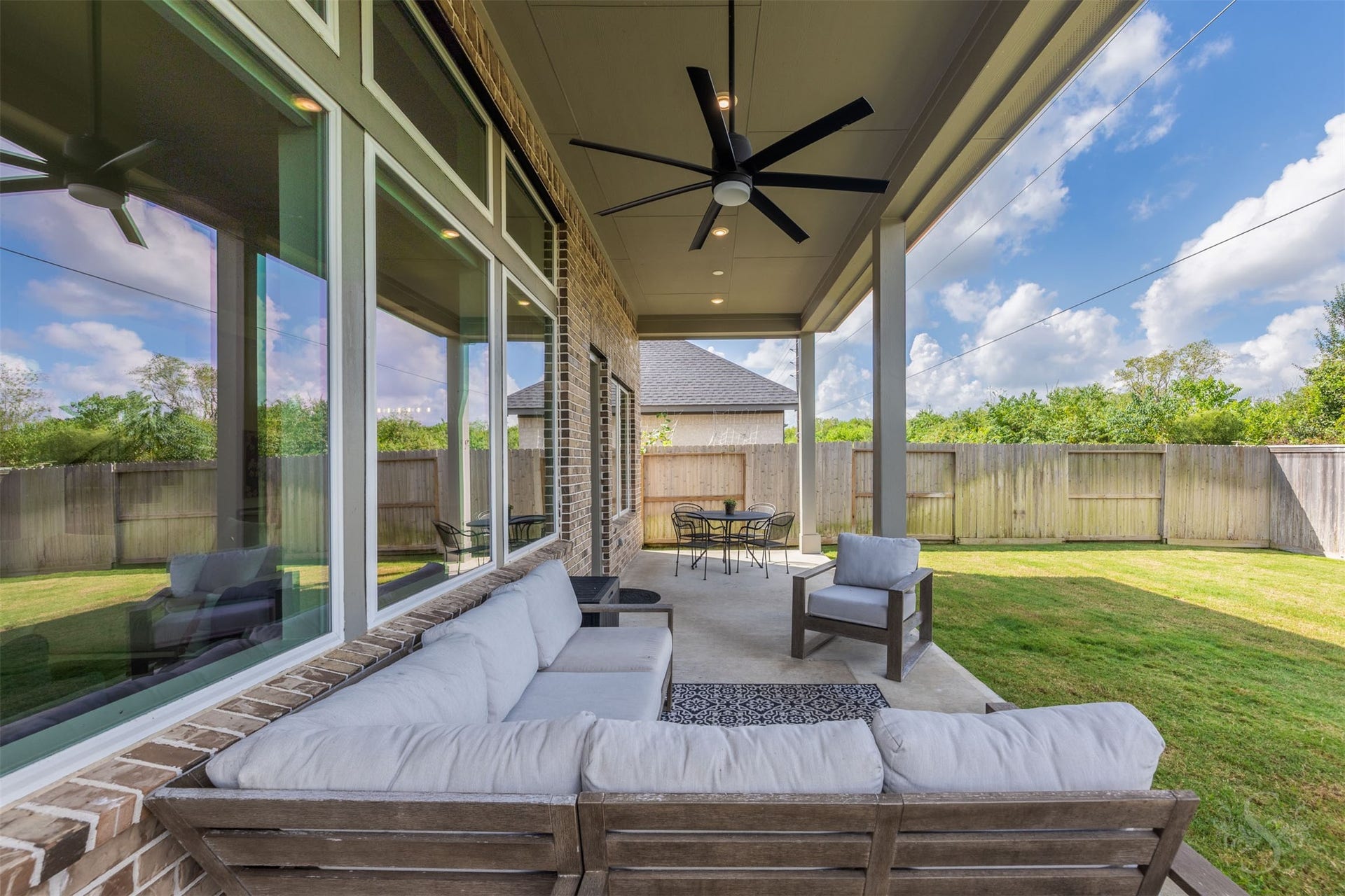Oversized covered patio extends the homes living space outdoors with recessed lighting and an impressive ceiling fan. Its an inviting setting for alfresco dining, entertaining or relaxing while enjoying the greenbelt views.