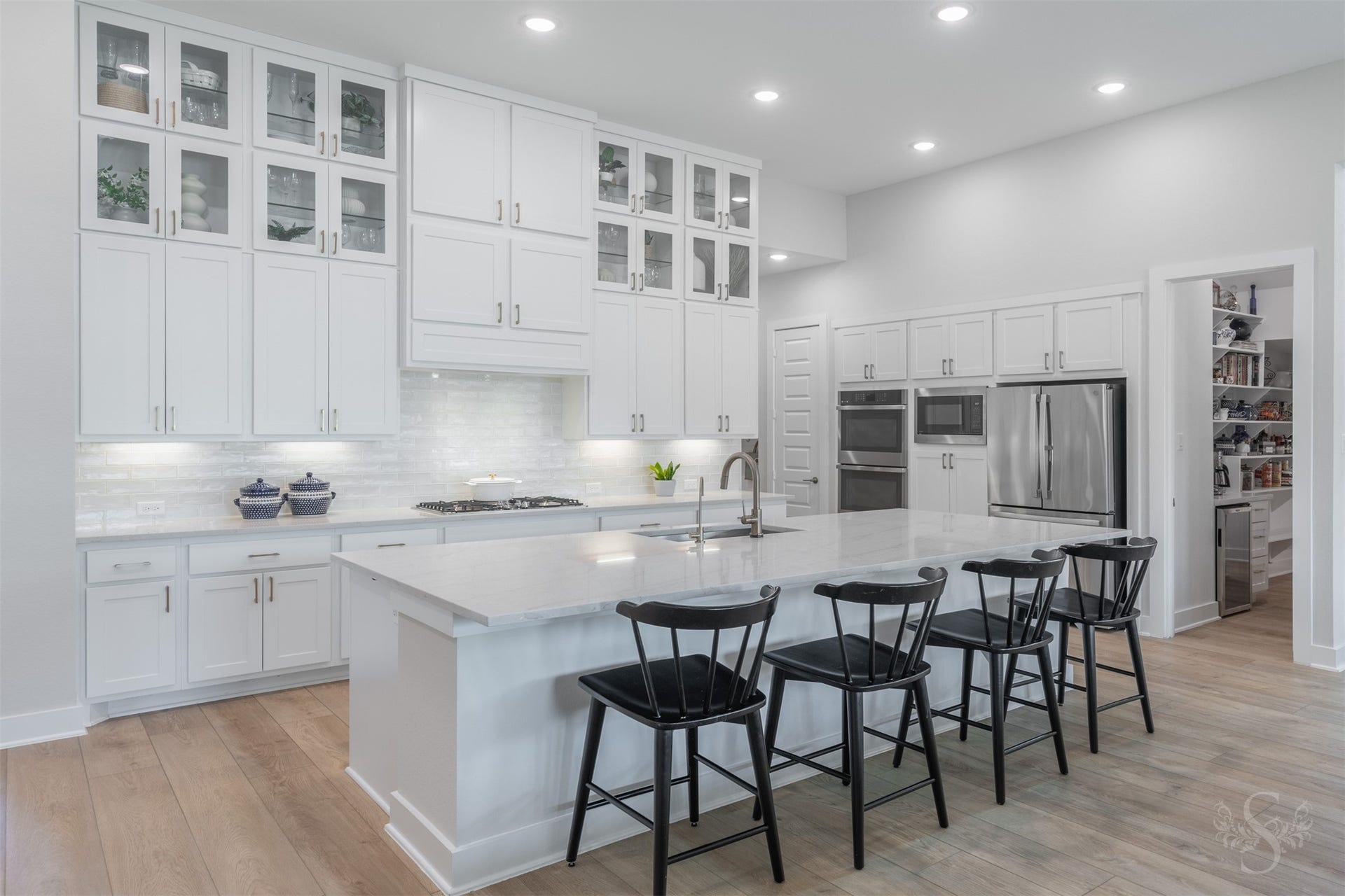 The expansive quartz island provides an incredible amount of room for meal preparation, serving and gathering. The breakfast bar makes it a natural centerpiece for everyday living and entertaining.