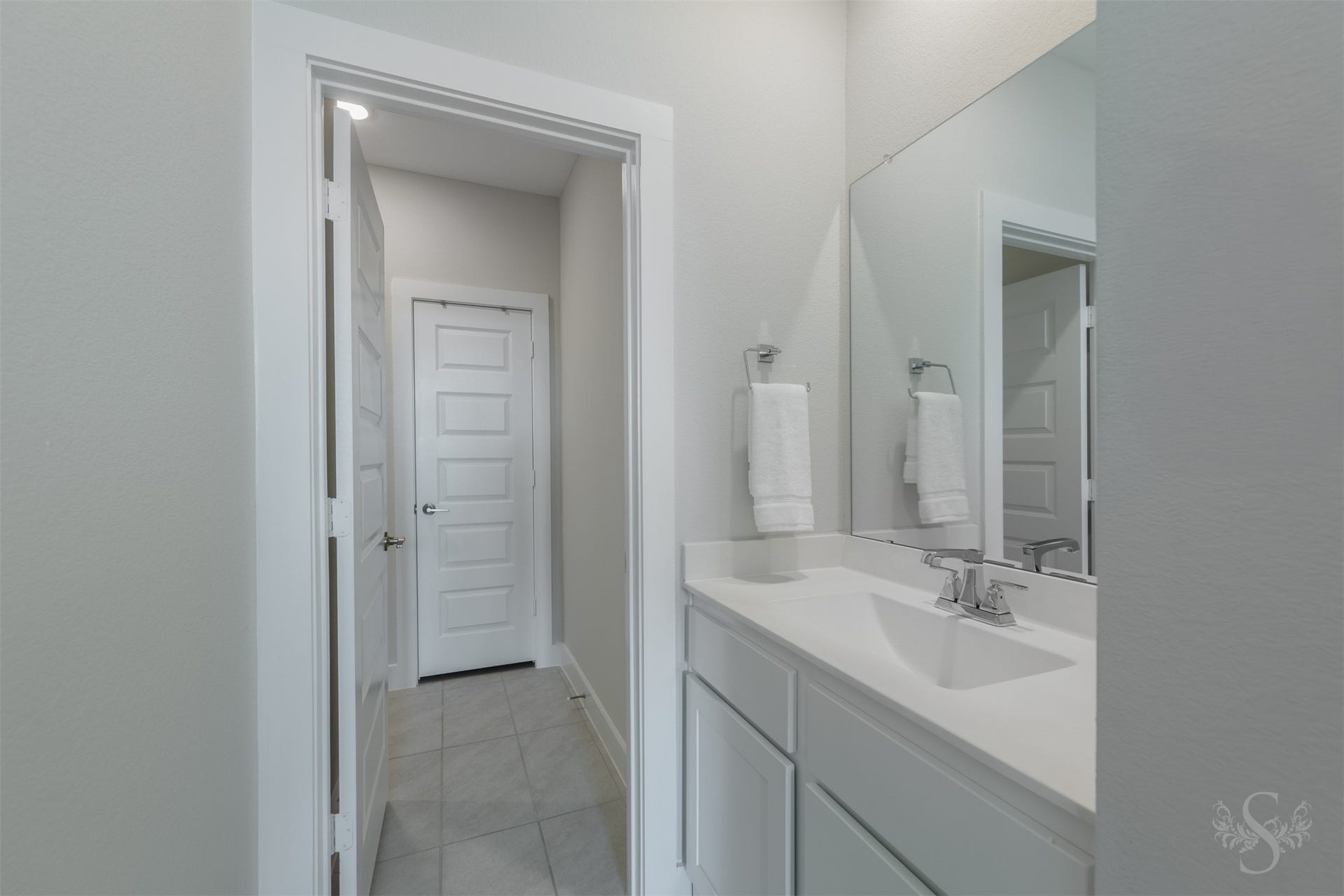 Private vanity area adds convenience to the upstairs accommodations with abundant counter space and a large mirror. Its modern finishes create a clean, upscale presentation.
