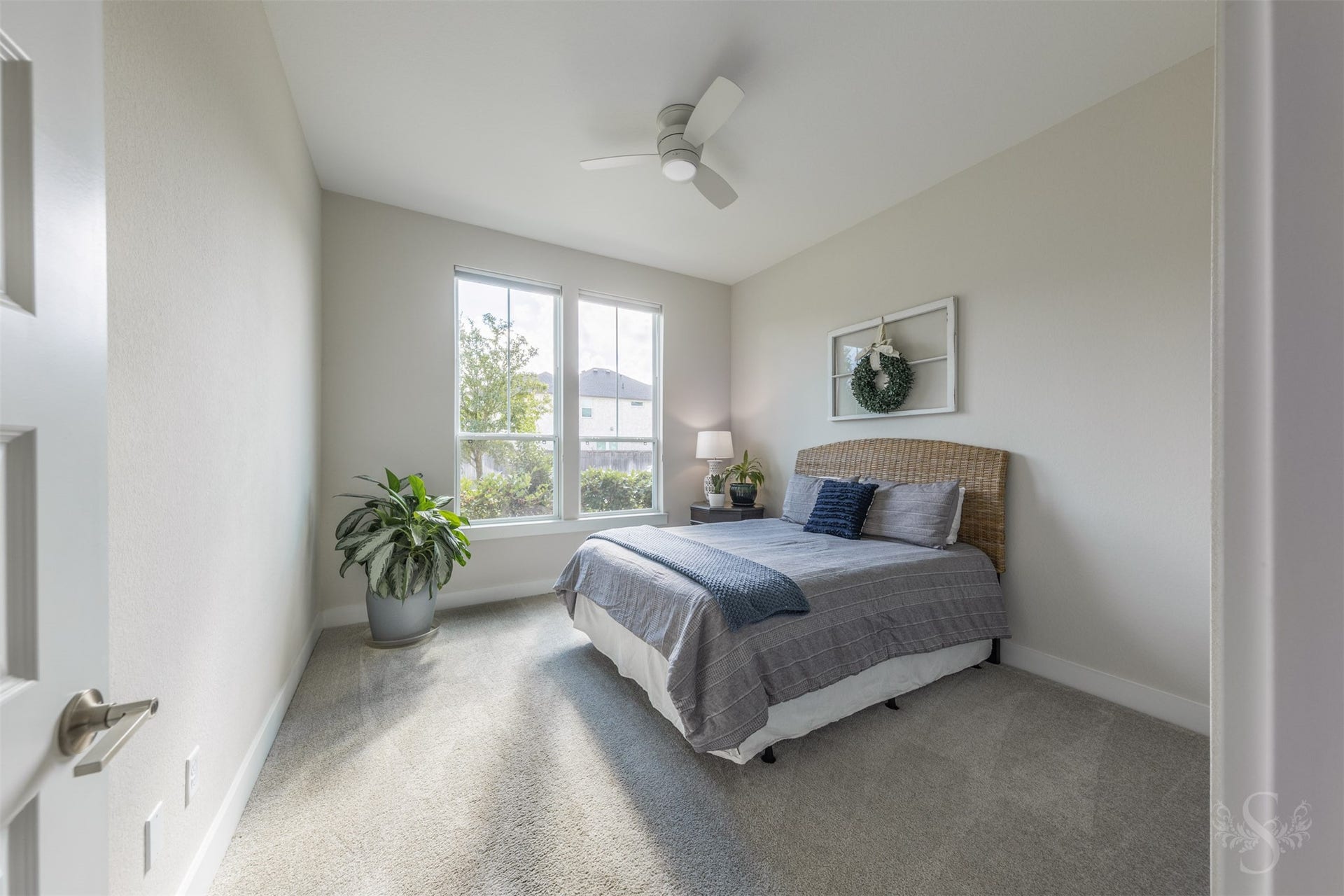 Privately situated downstairs, the spacious secondary bedroom is filled with beautiful natural light and offers an inviting retreat for overnight guests or multigenerational living.