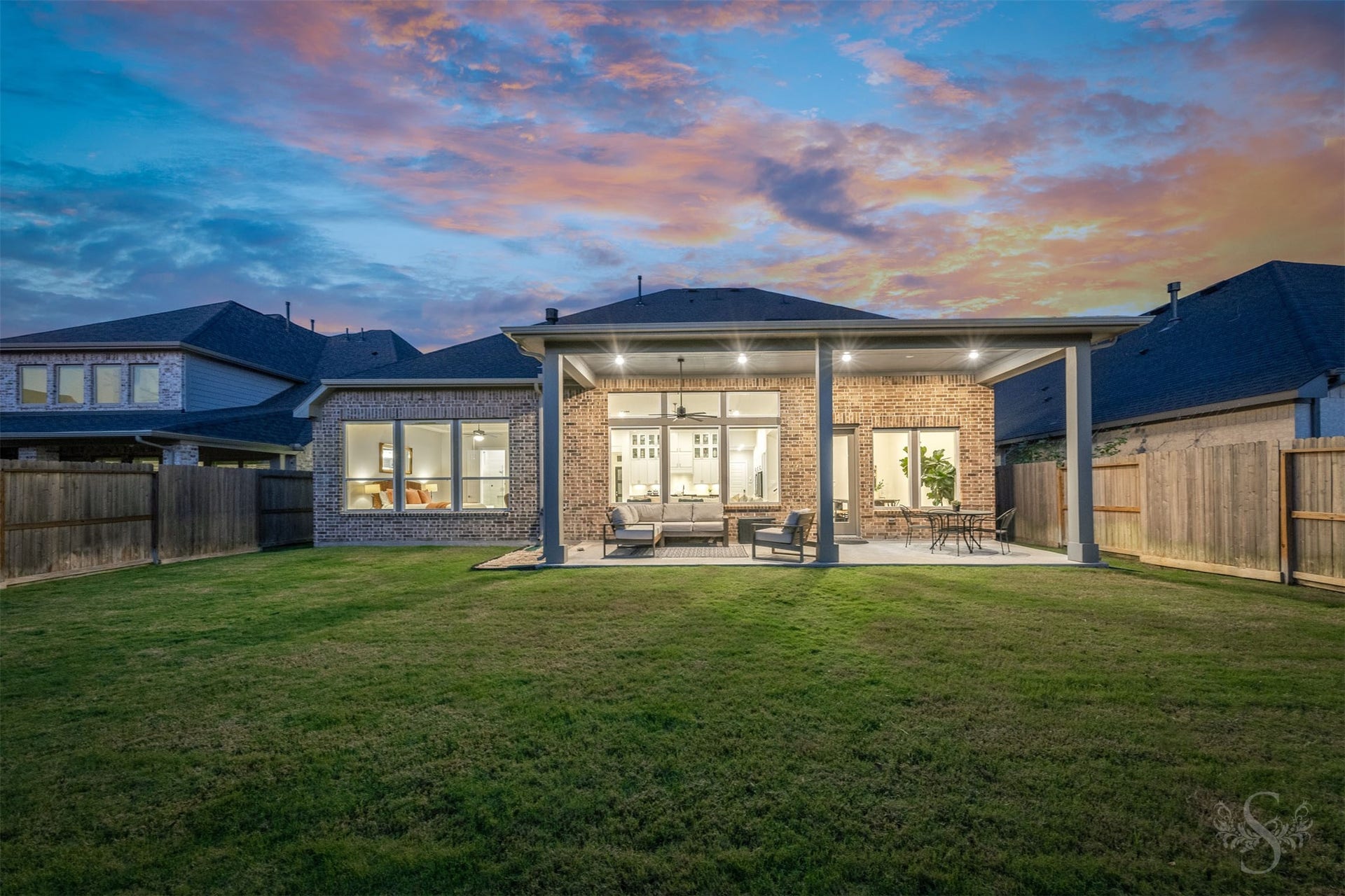 The extended covered patio creates a beautiful outdoor living space with plenty of room for relaxing and entertaining. Beyond the patio, the spacious fenced backyard offers endless possibilities for outdoor enjoyment.