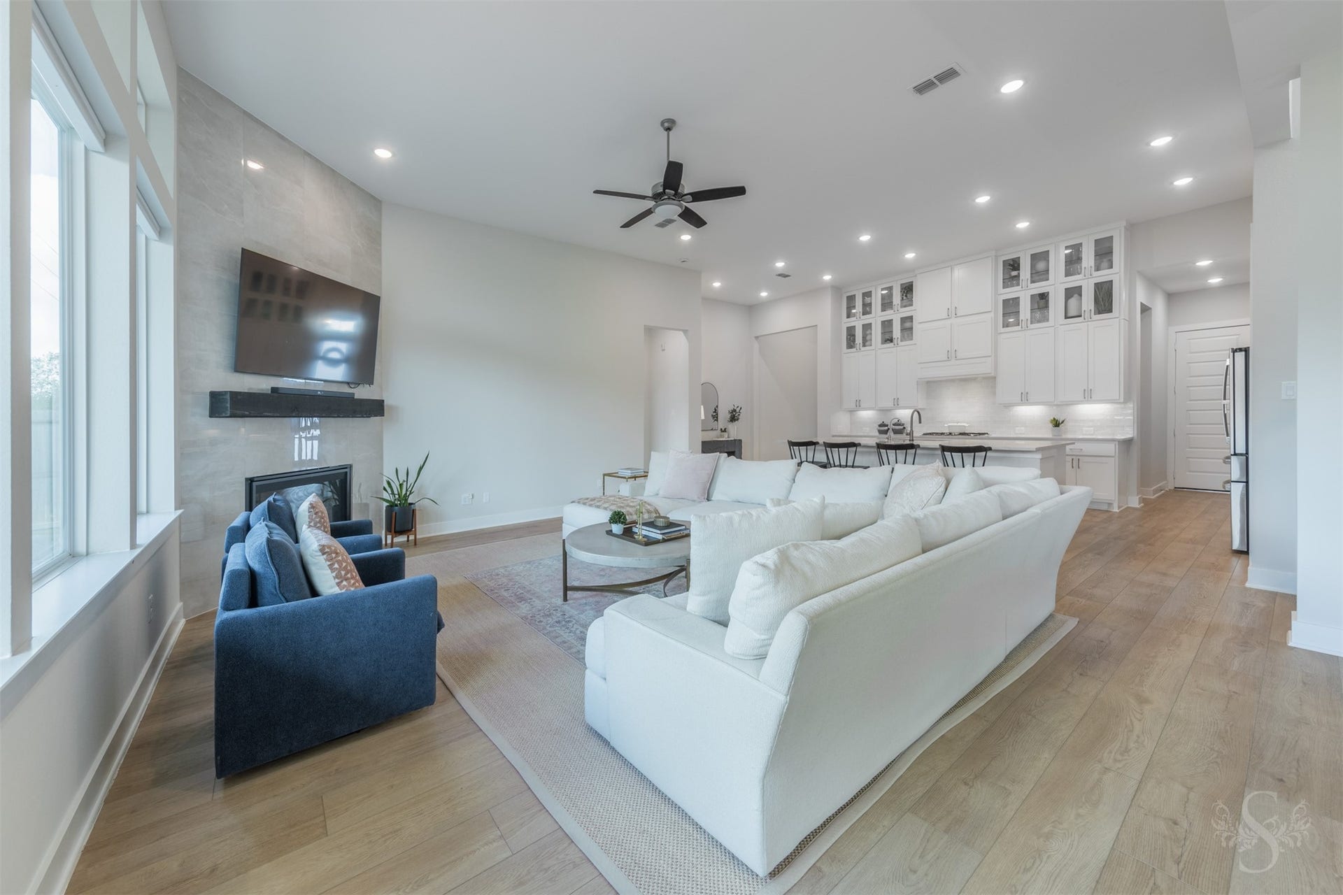 This inviting view highlights the impressive size of the family room and its connection to the stunning kitchen. Gorgeous flooring carries throughout the open living spaces for a cohesive designer look.