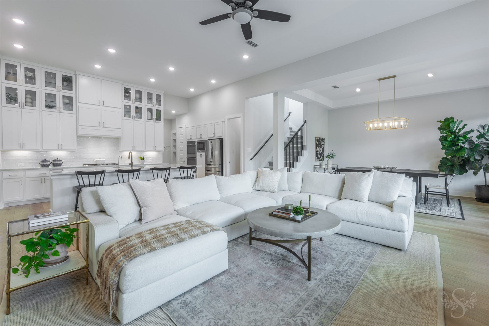 The spacious family room offers abundant seating space while remaining open to the kitchen and dining area. Its open-concept design creates a beautiful setting for entertaining on any scale.