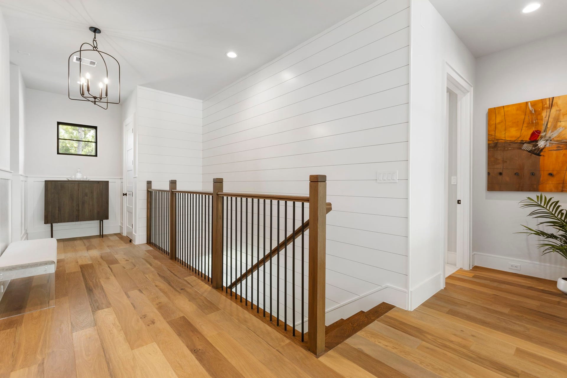 The engineered wood flooring continues to the second level.