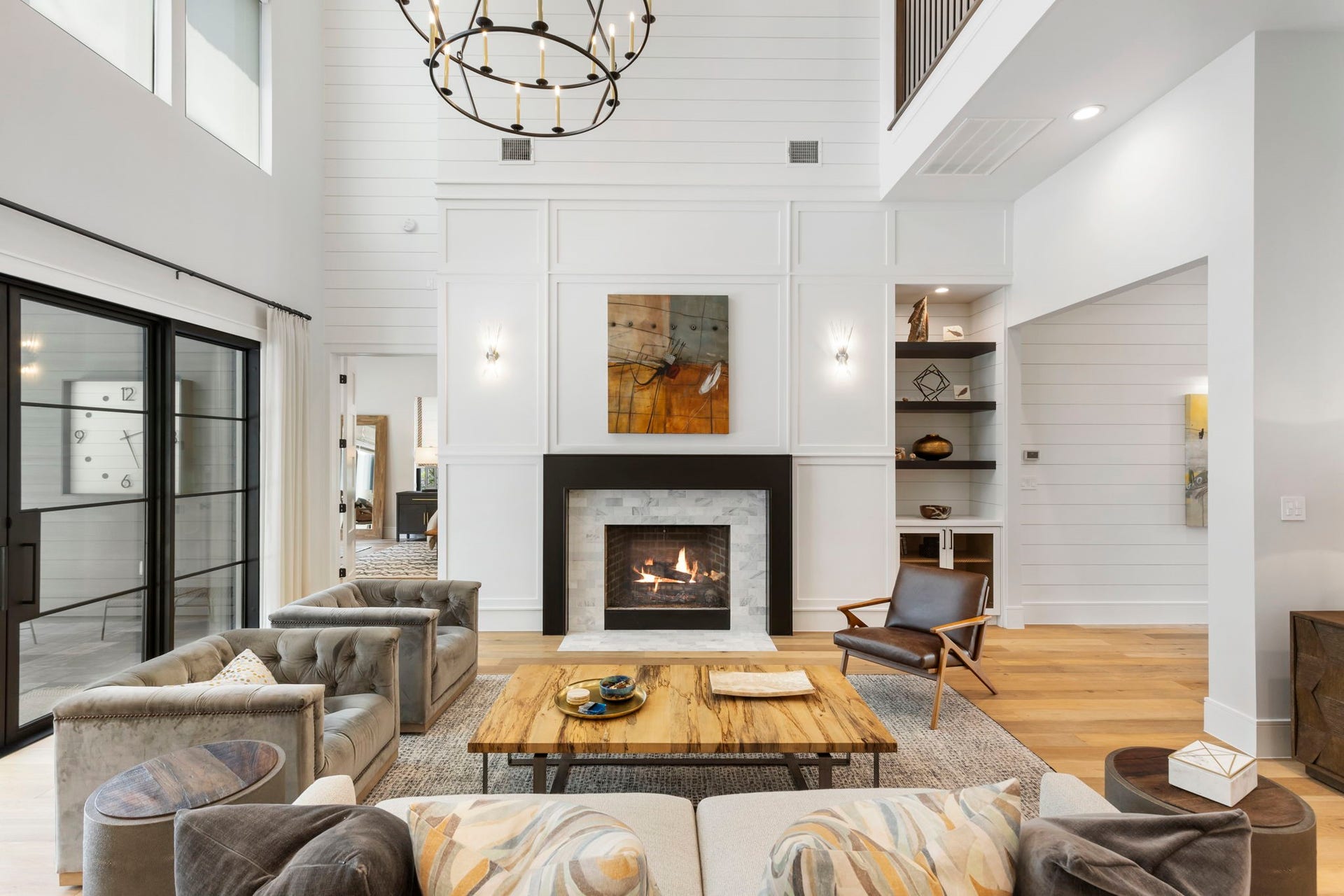Soaring two-story ceiling and statement gas fireplace beautifully anchor this formal living room.