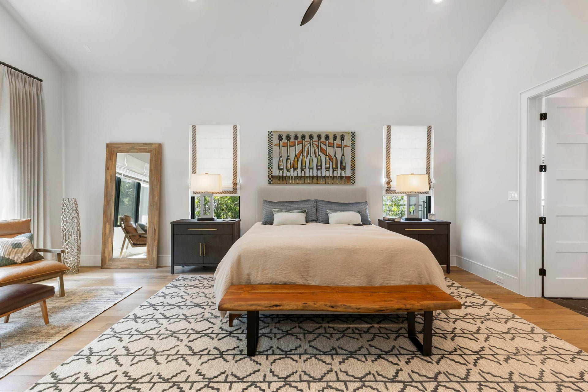 Offering plenty of wow-factor all it's own, the primary retreat impresses with soaring vaulted ceiling and a light, neutral color palette.