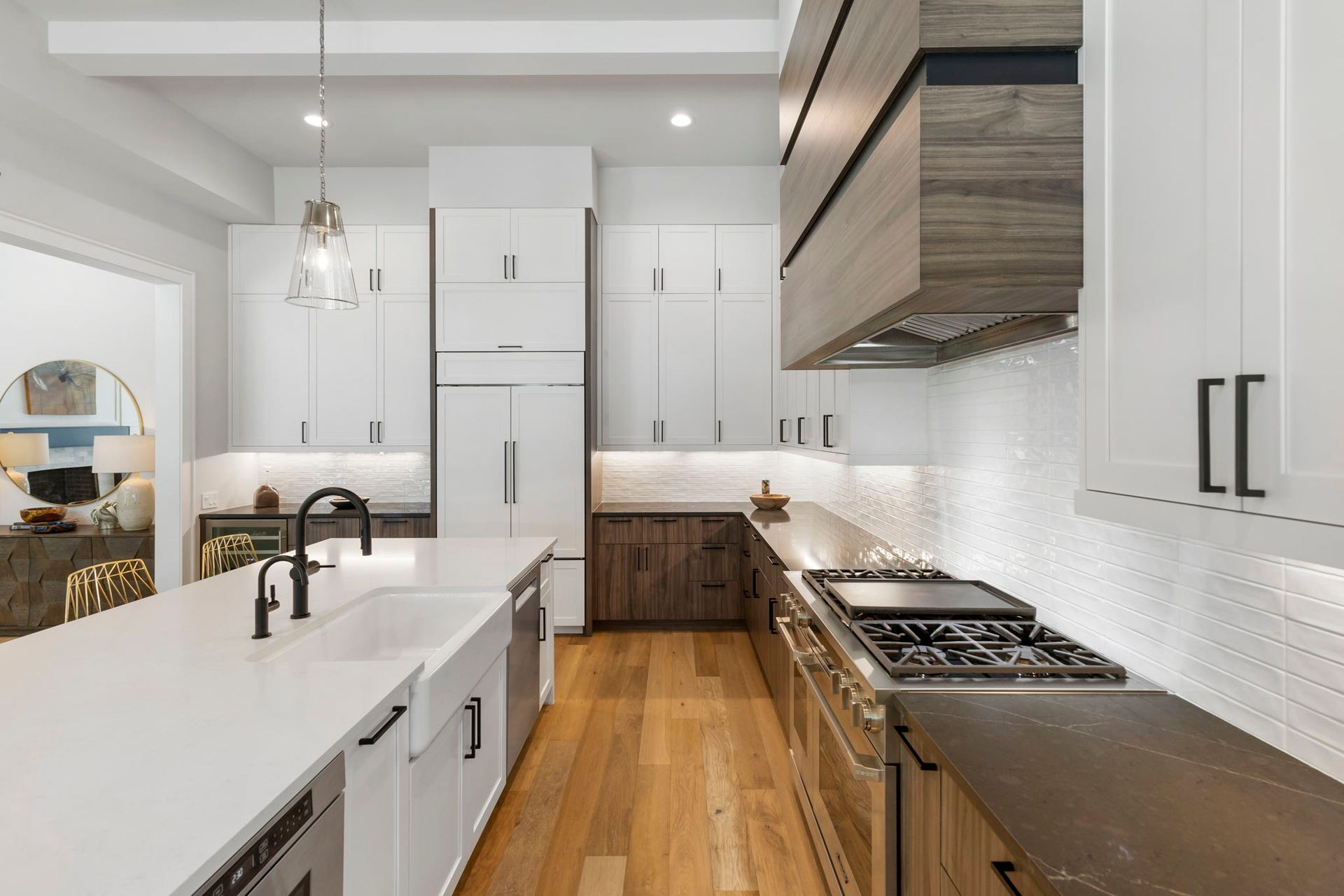 High-end appliances  including Sub-Zero fridge and Dacor Range/Ovens  pair with soft-close custom cabinetry and under-cabinet lighting for a kitchen built to impress.
