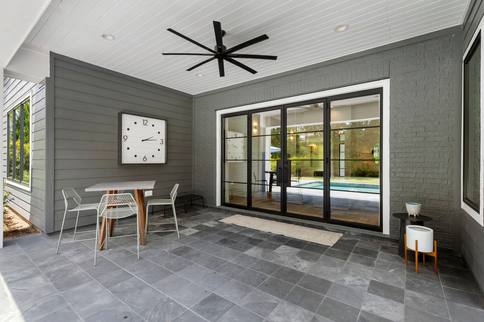 Generous covered outdoor living space with finished ceilings and fans.