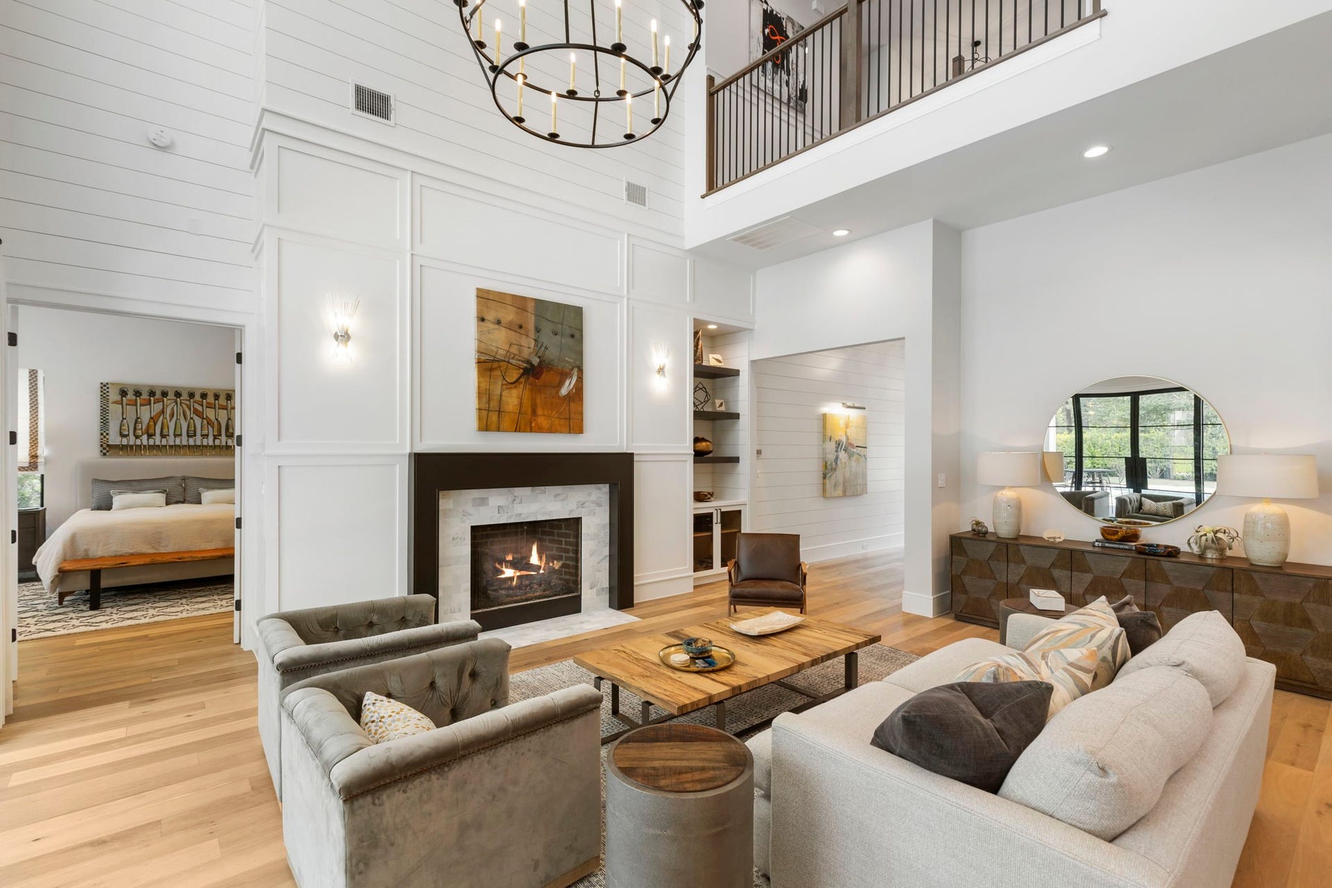 Left of the fireplace, paneled French doors open into the homes primary retreat.