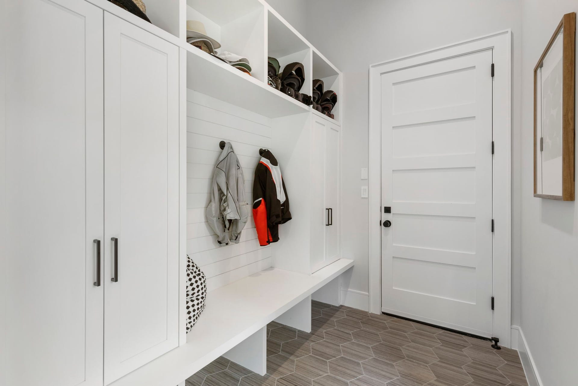 Around the corner and off the 3-car garage, a mud room offers built-in lockers, bench and storage cubbies.