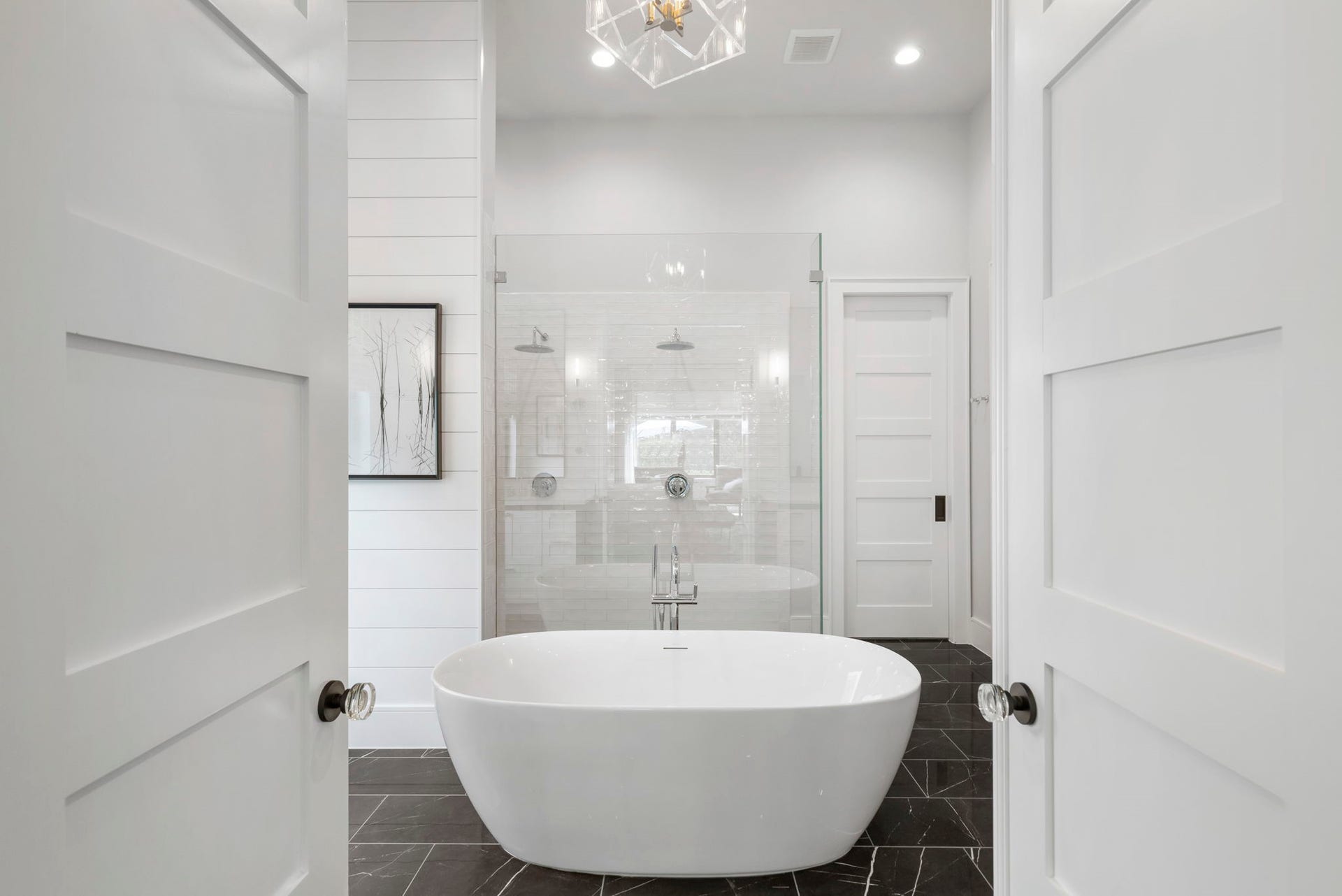 To the right of the space, French doors open into the resort style bath.